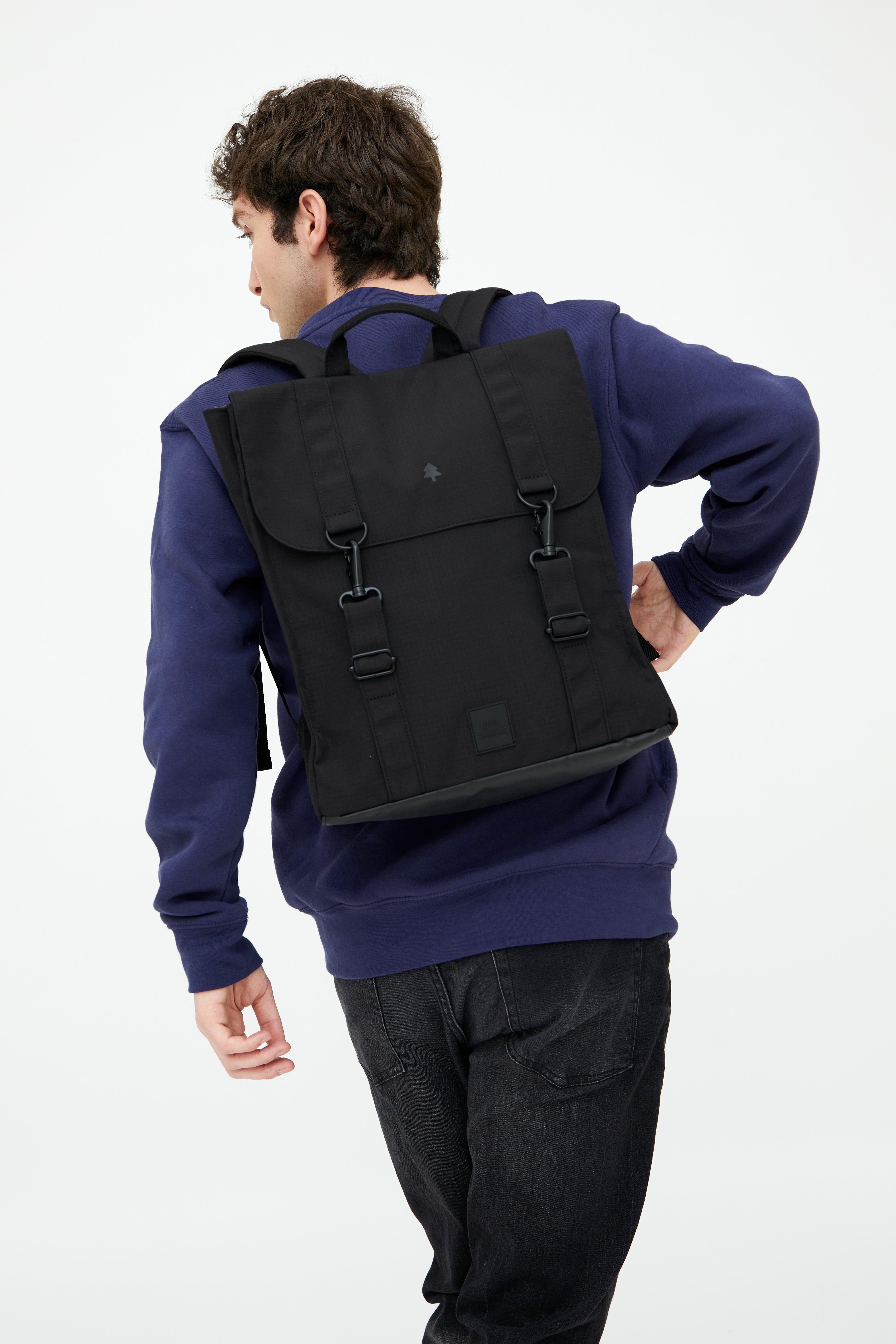 Person wearing a black backpack on a white background