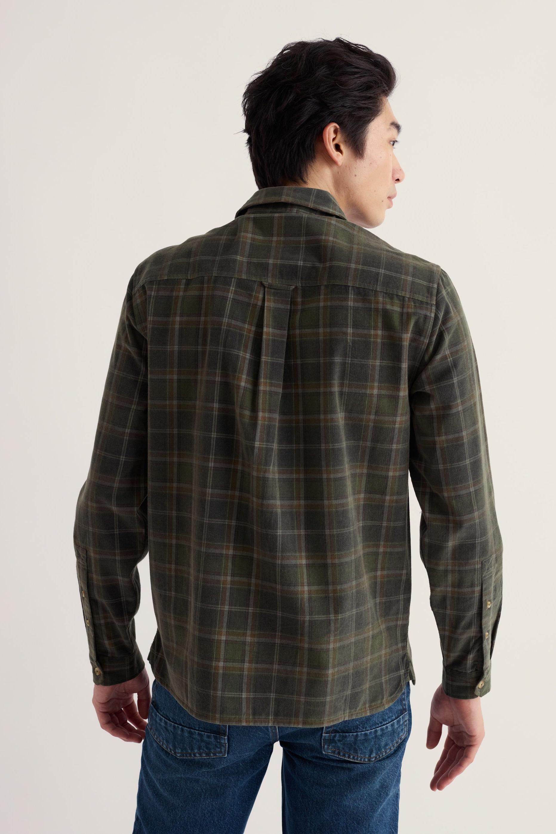 The back view of a men's cotton cord shirt in a plaid print