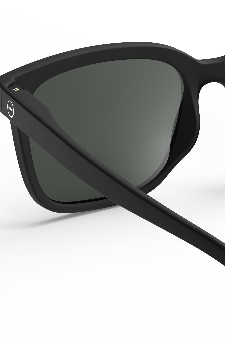 Close-up of matte black Izipizi sunglasses with dark lenses against a white background.