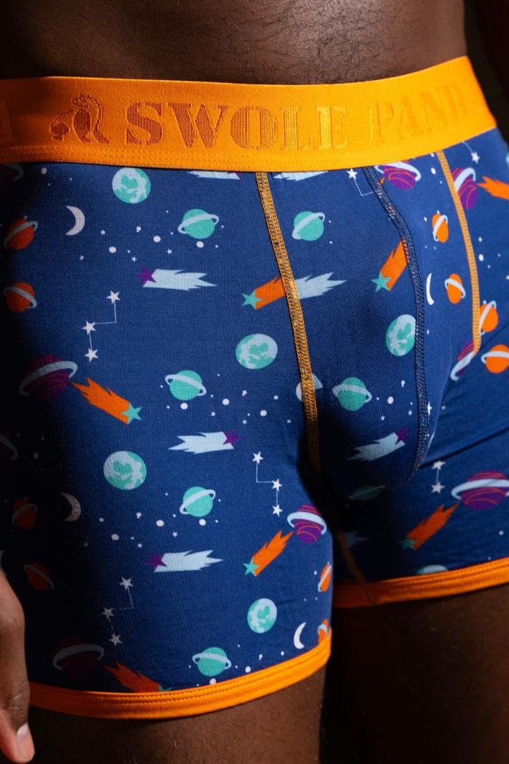 Close-up of men's bamboo boxers featuring a vibrant outer space theme with planets and comets.