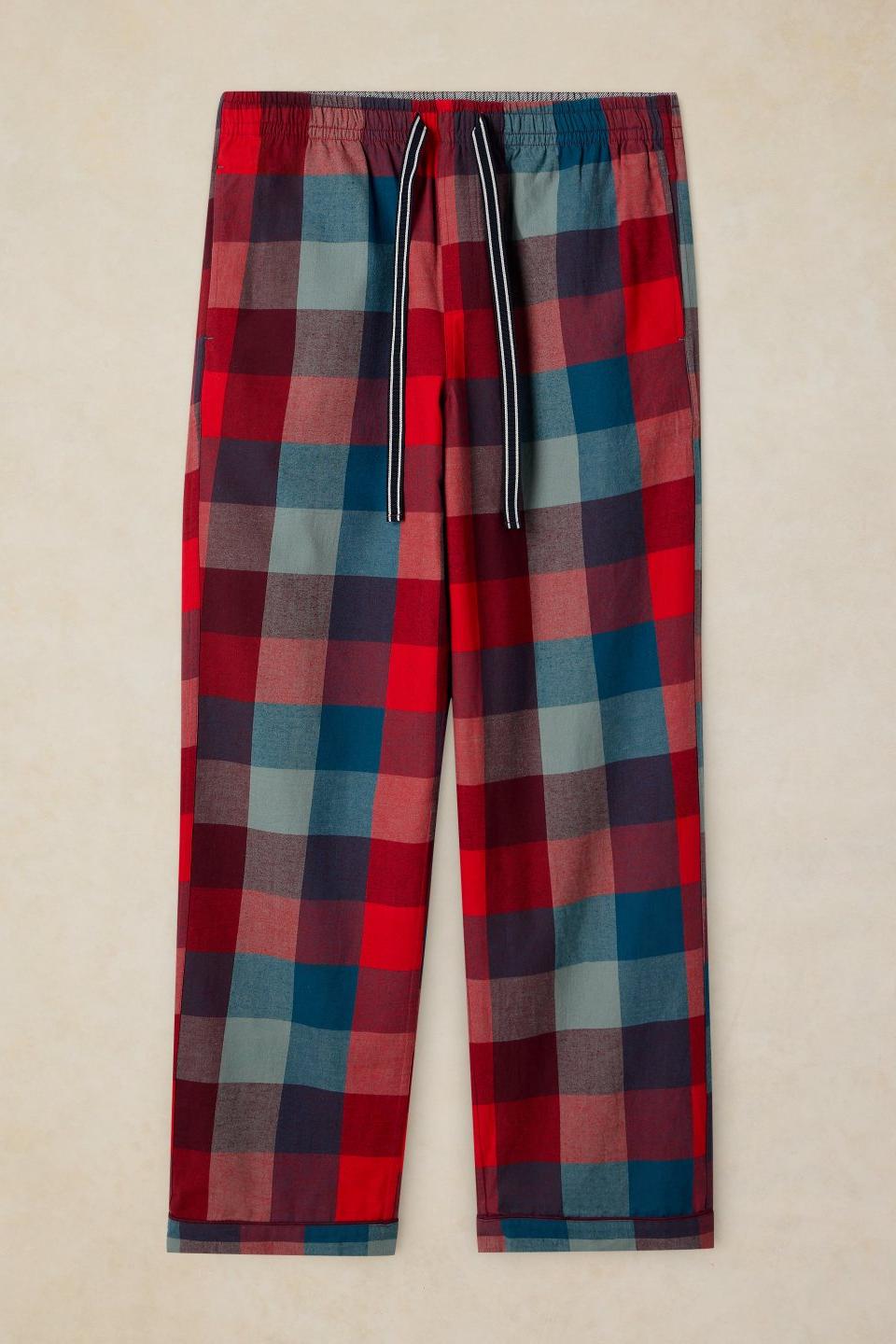 Men's organic cotton pyjama bottoms in a red and blue check pattern with a drawstring waist.