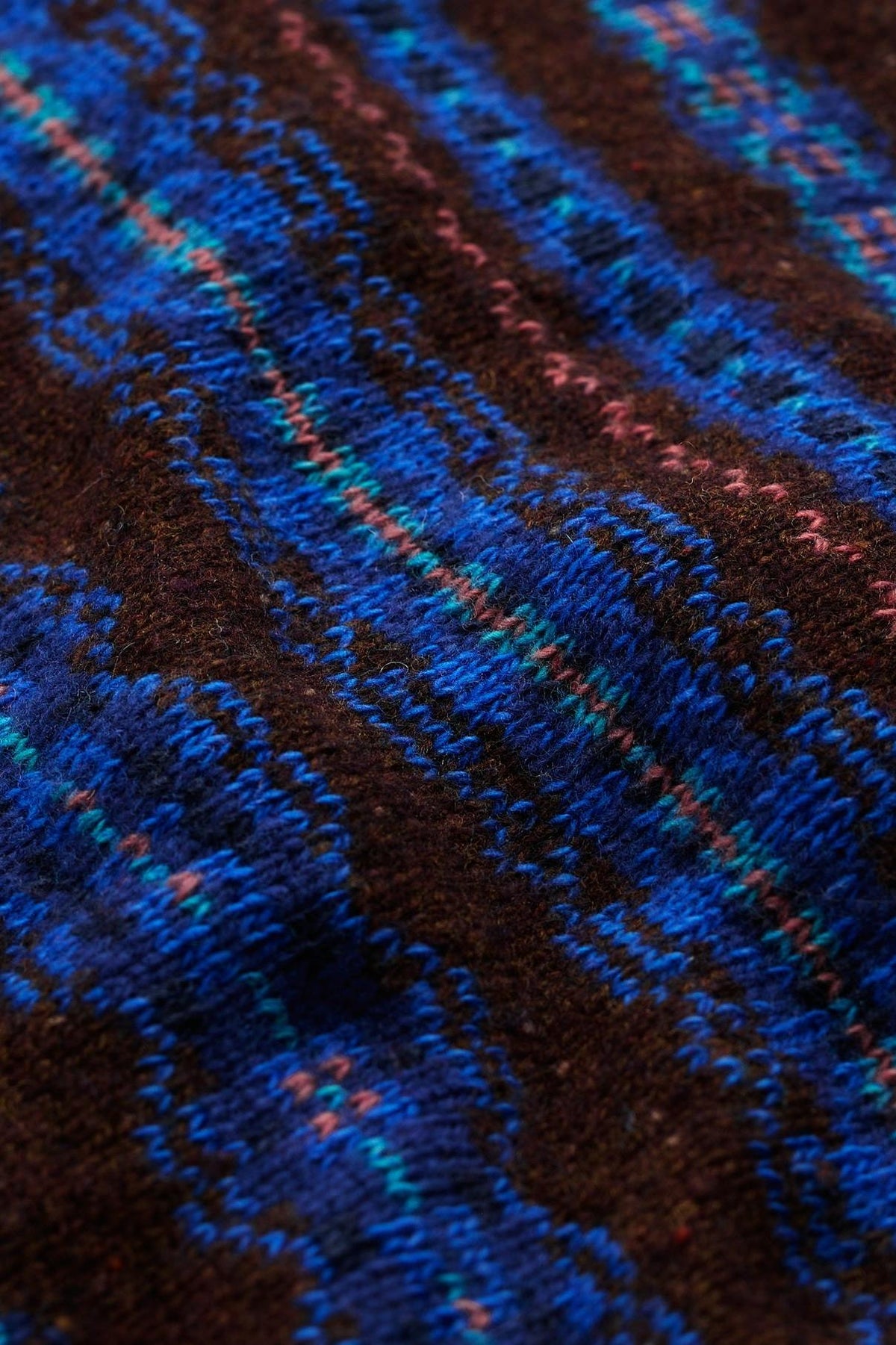 Close-up of a blue and brown patterned Merino wool knit snood with soft texture.