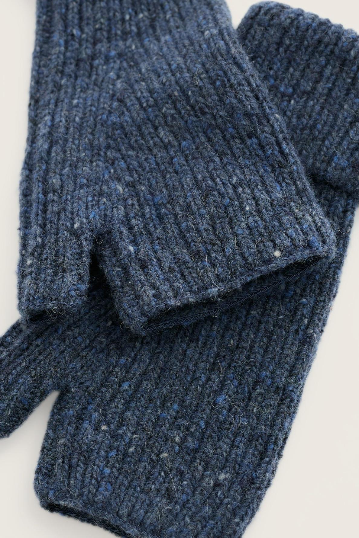 A pair of textured navy blue merino wool fingerless gloves resting on a plain white surface.