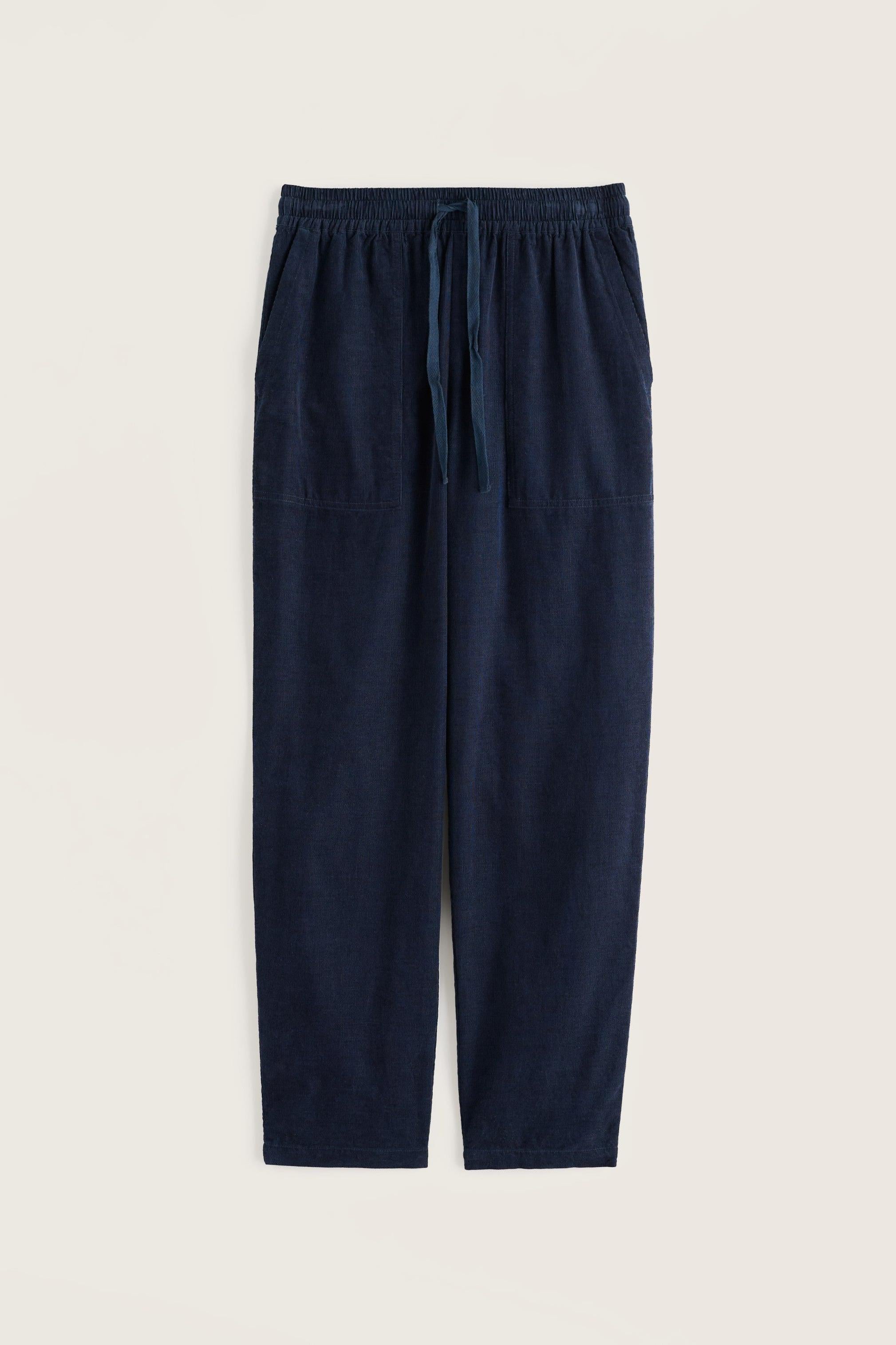 A pair of dark navy blue linen pants with an elastic waistband and drawstring, displayed flat against a light beige background.