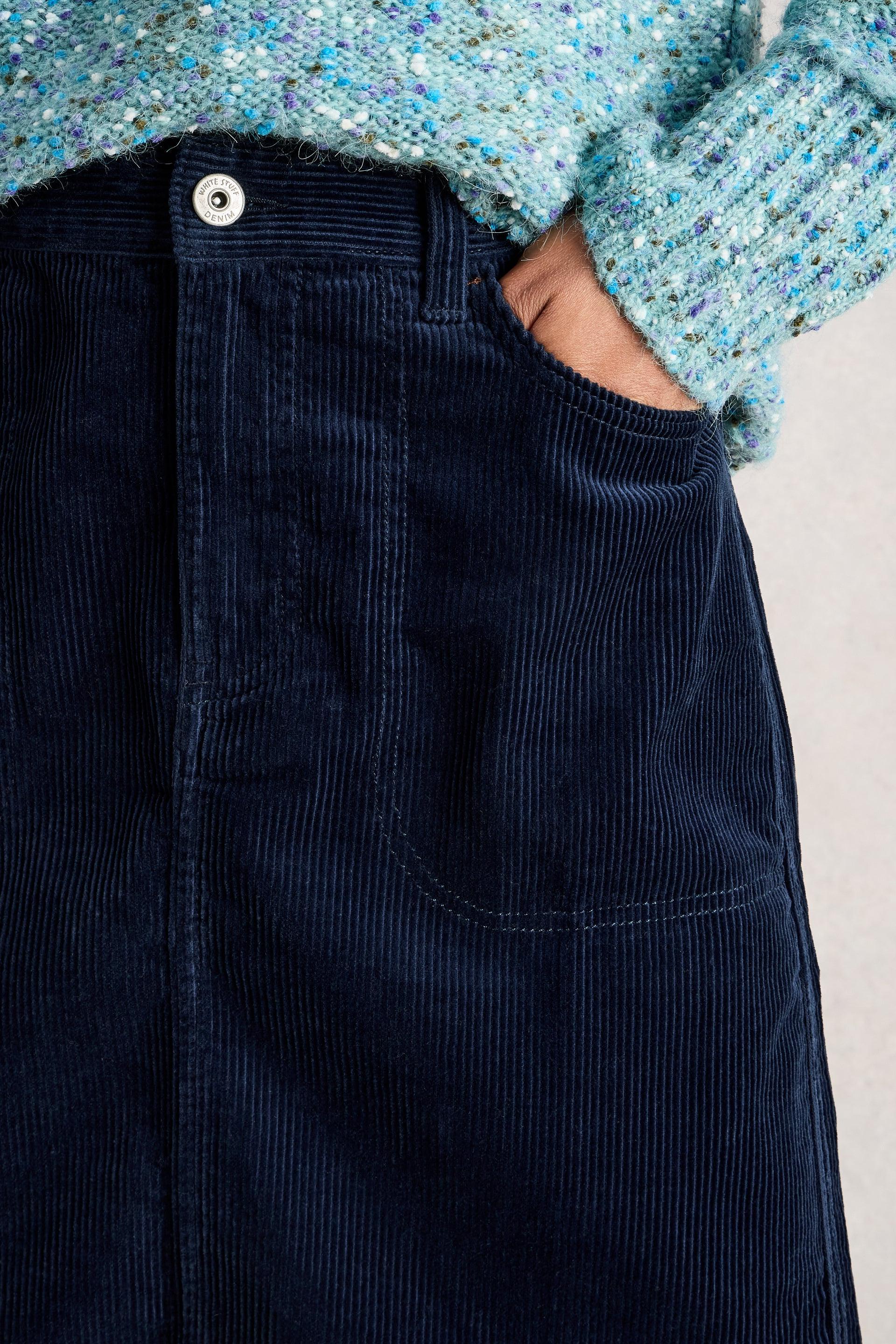 Navy corduroy skirt with a light blue textured sweater