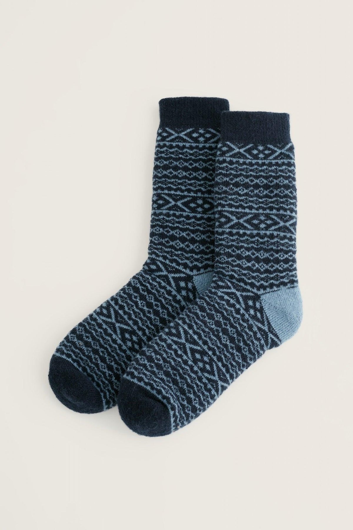 Pair of navy blue patterned Seasalt Cornwall cabin socks on a light background