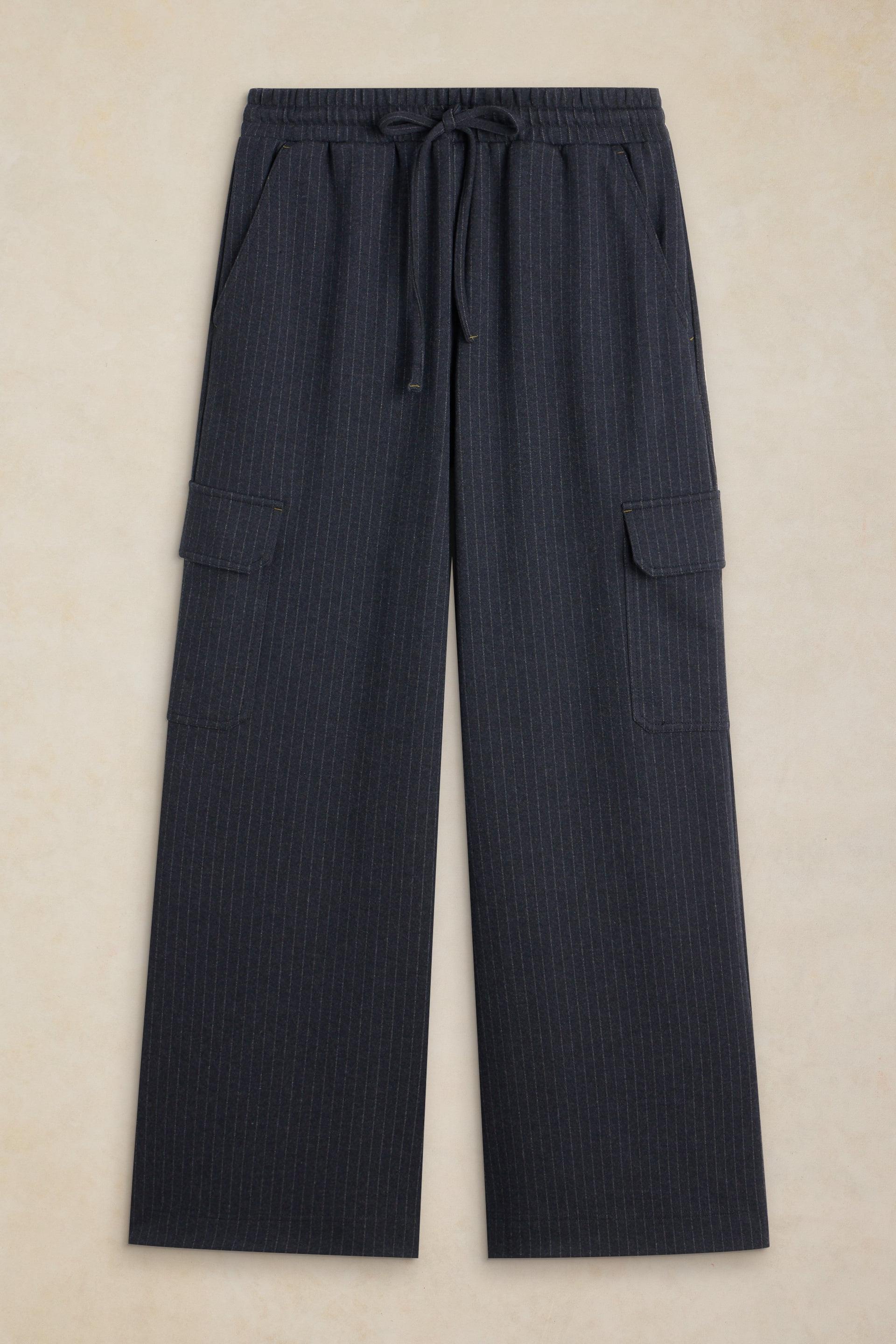 Dark navy pinstriped wide-leg cargo pants with an elastic drawstring waist, laid flat on a beige background.