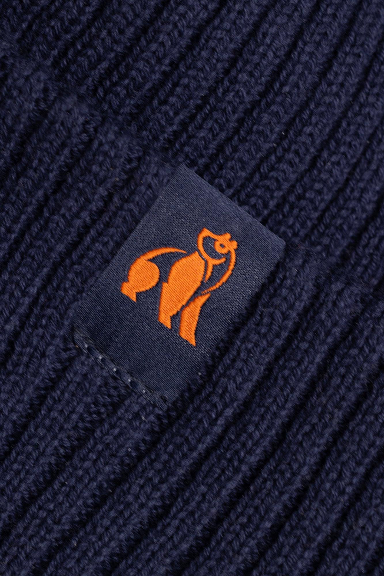 Close up of a dark navy ribbed beanie with an orange Swole Panda brand logo label.
