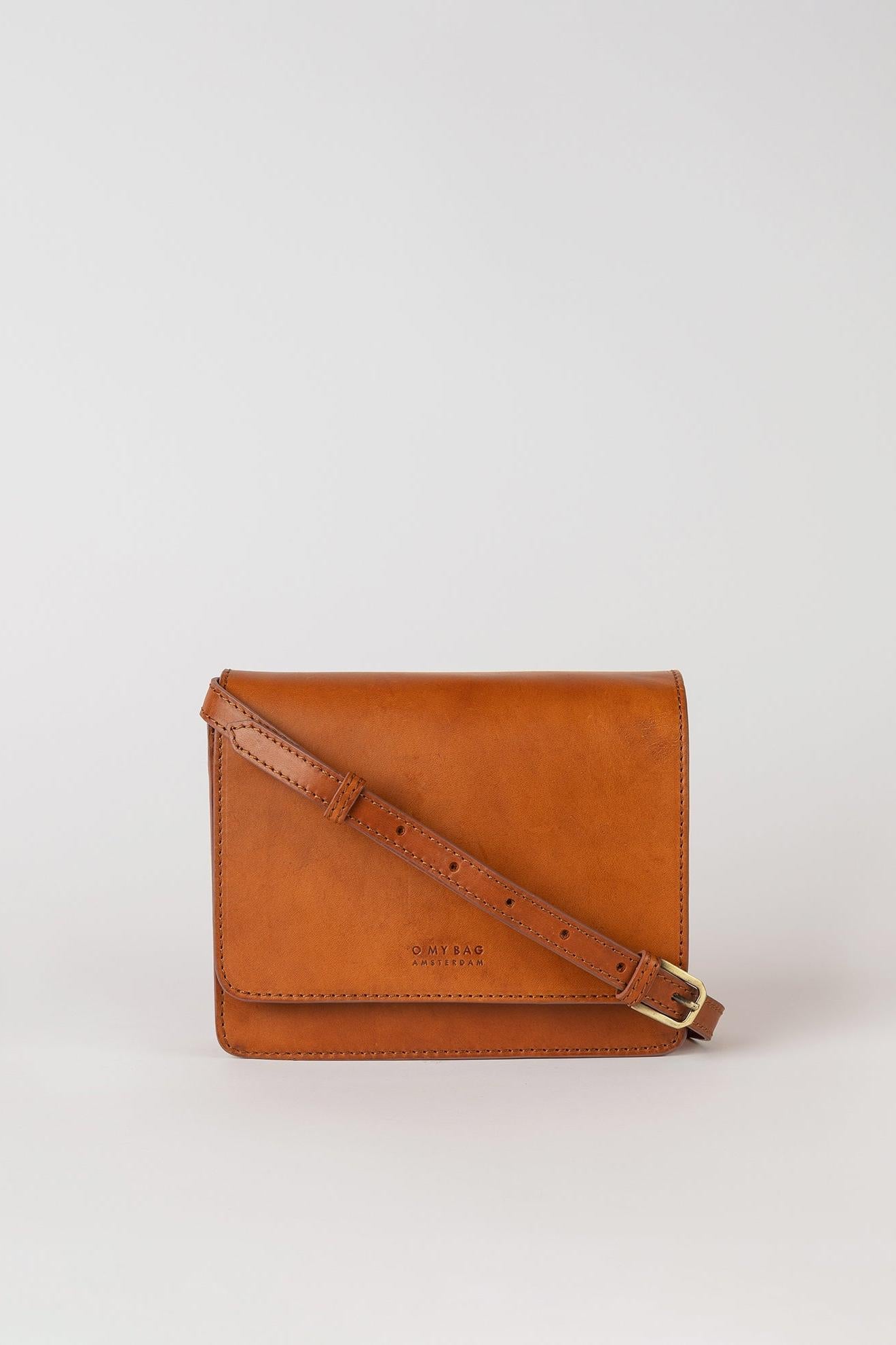 Brown leather crossbody bag on a light gray background