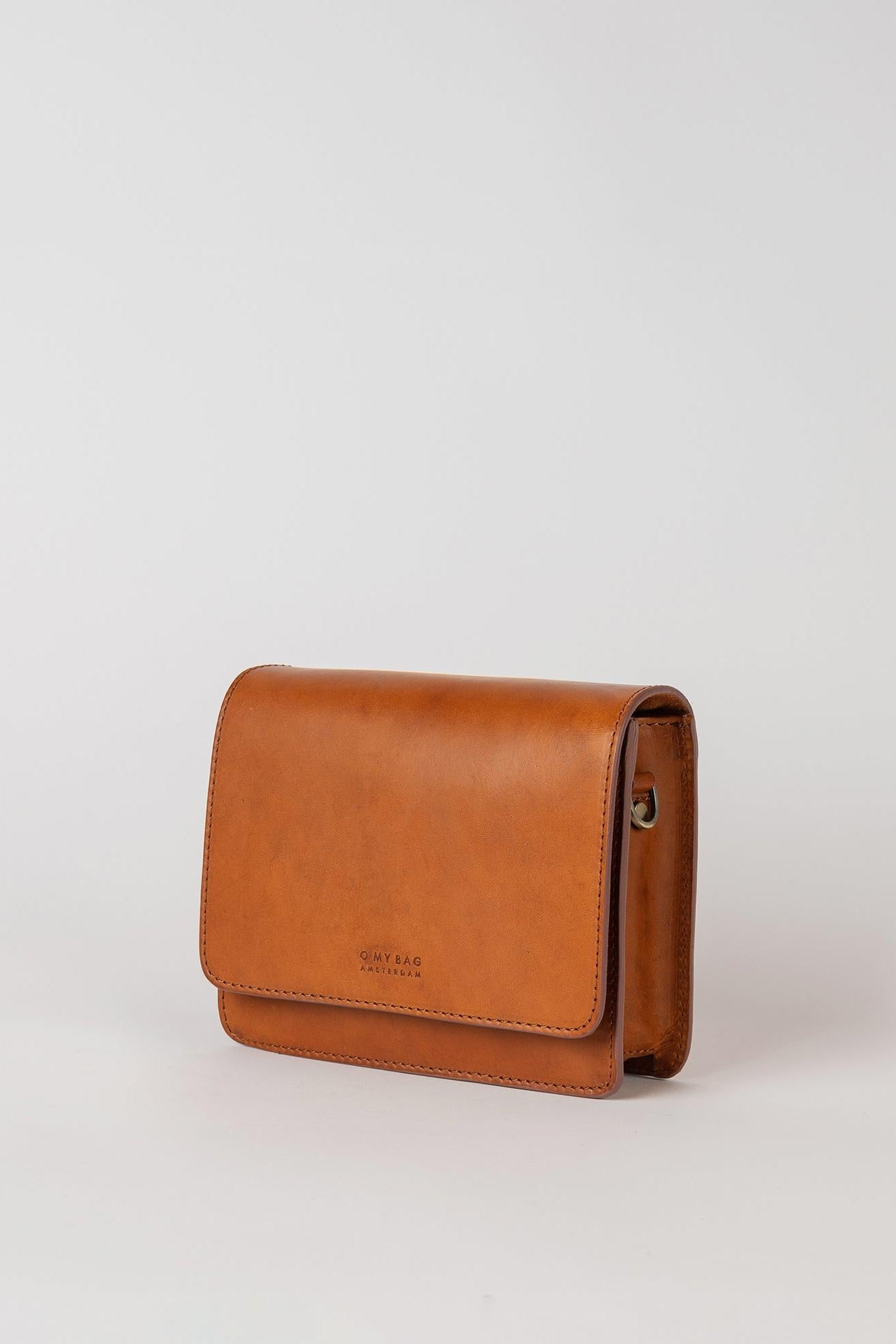 Brown leather crossbody bag on a light gray background