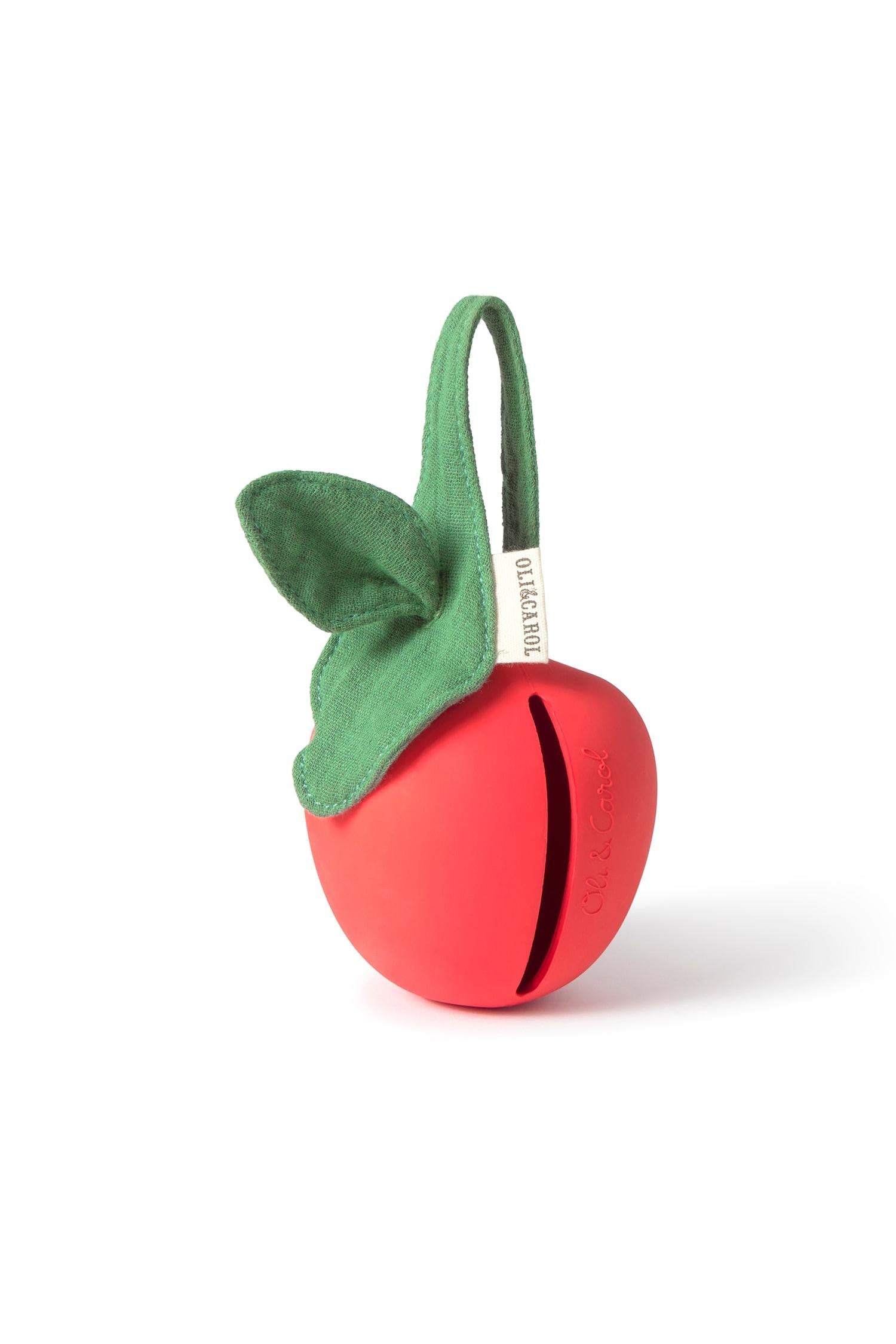 Red apple-shaped pacifier container with a green leaf on a white background