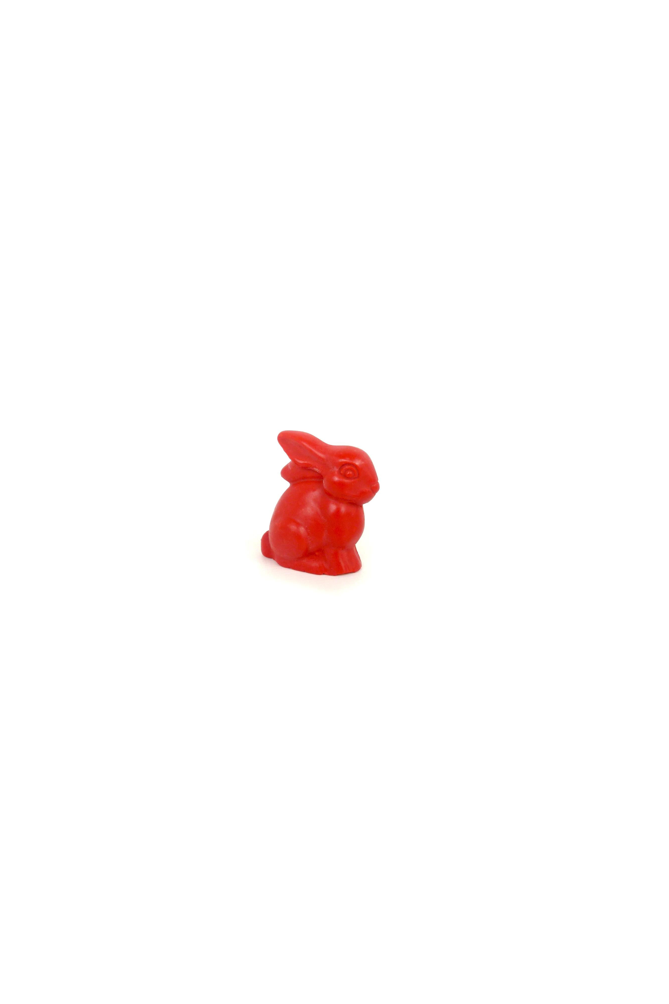 Red rabbit-shaped crayon on a white background