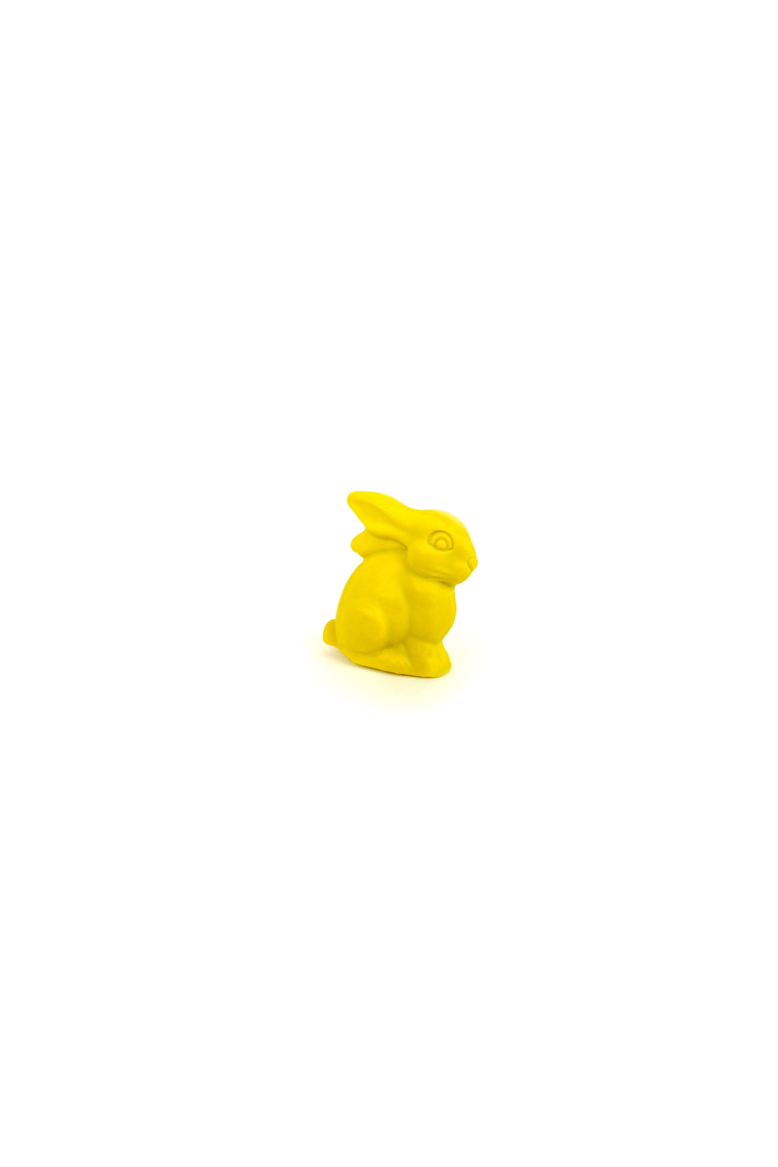 Yellow rabbit figurine crayon on a white background