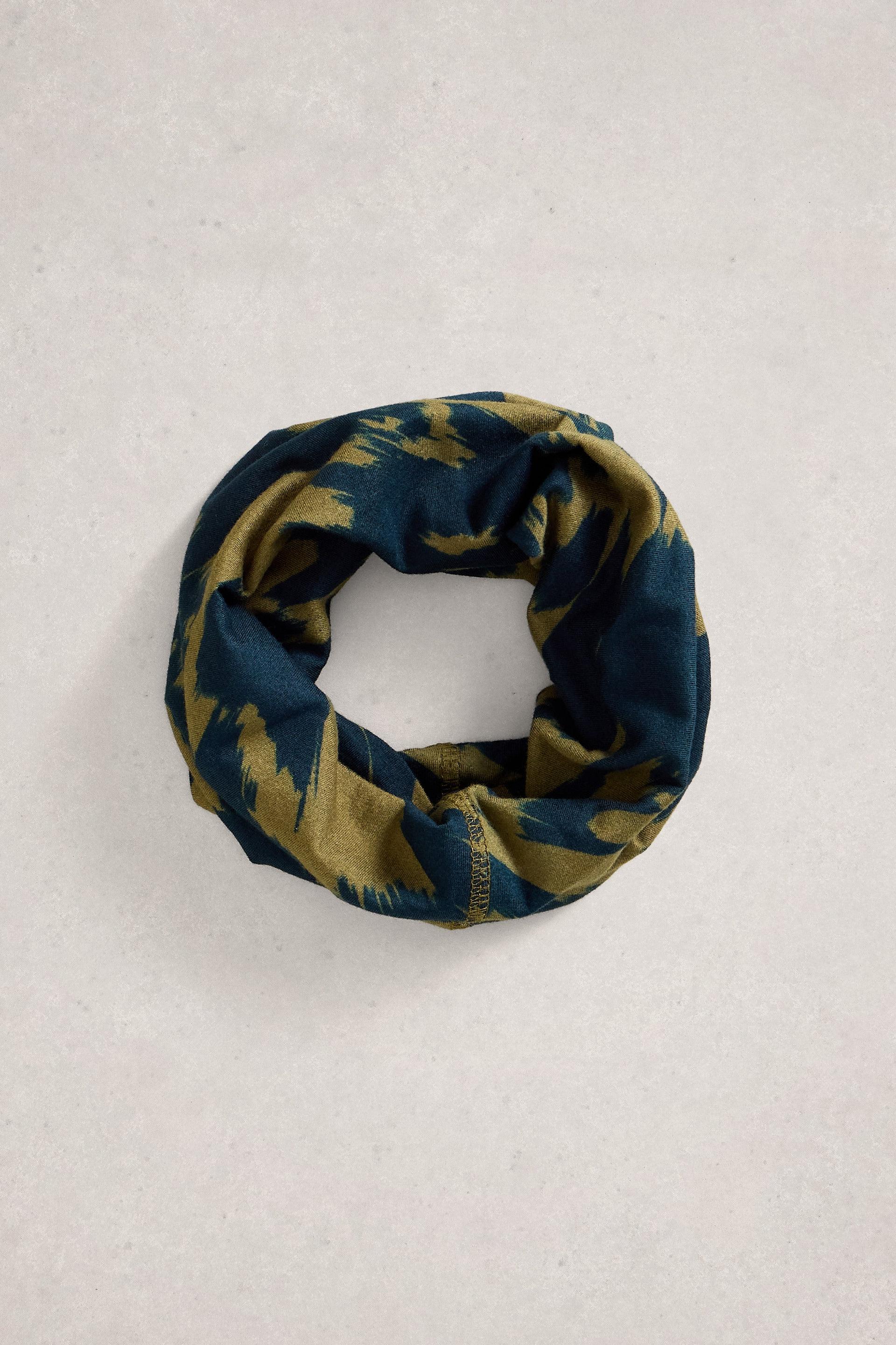 A circular neck gaiter featuring an olive green and navy blue abstract pattern on a light grey background