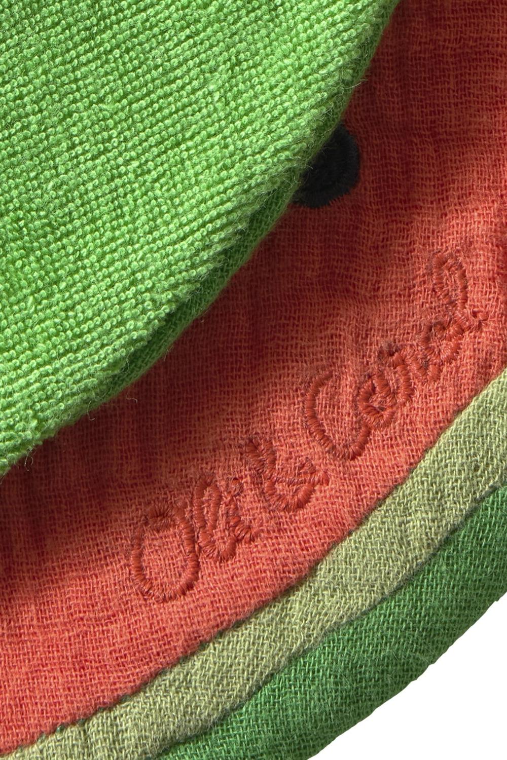 Close-up of green and red fabric with a brand logo.
