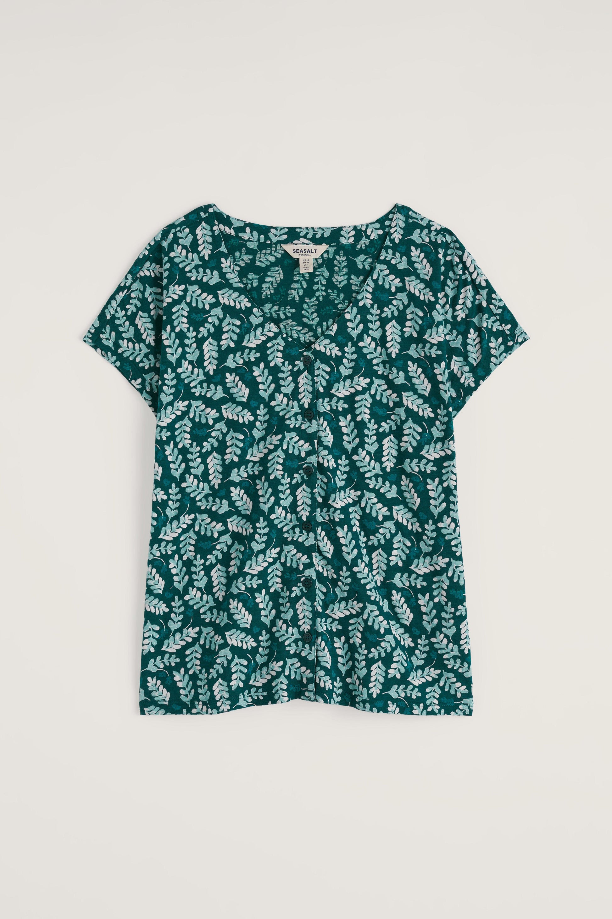 Green floral patterned shirt on a white background