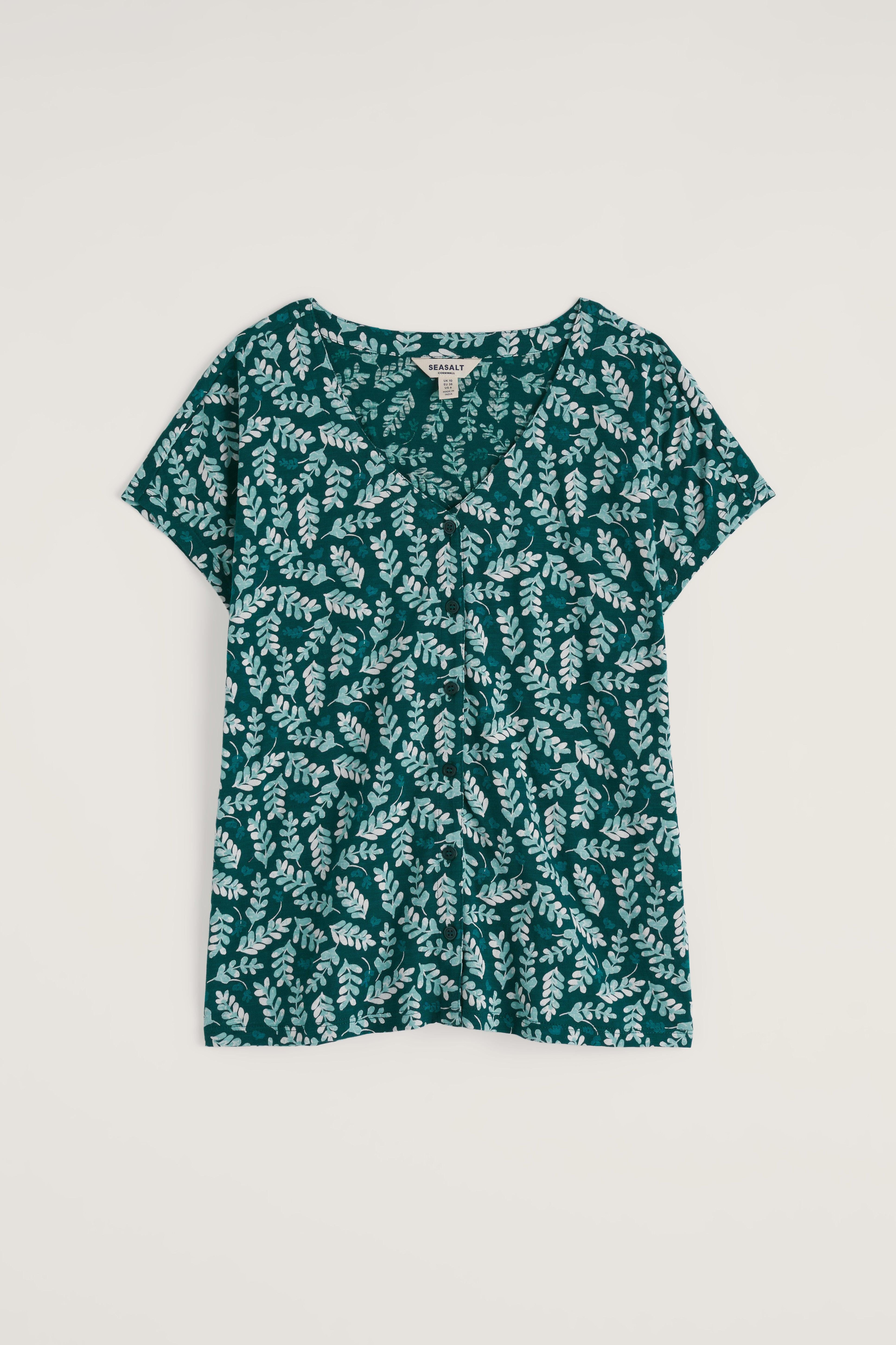 Green floral patterned shirt on a white background