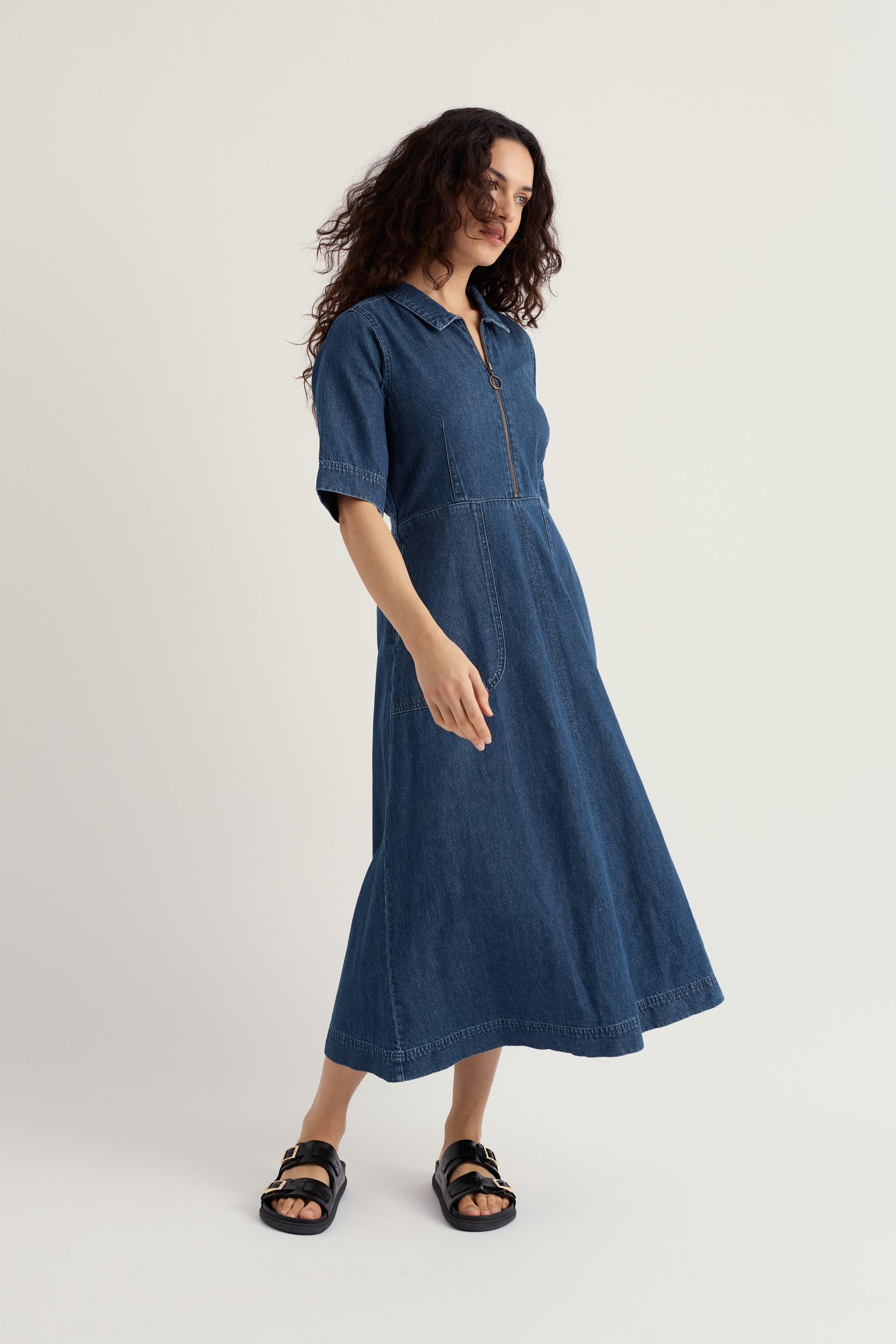 Woman wearing a blue organic cotton midi dress on a white background