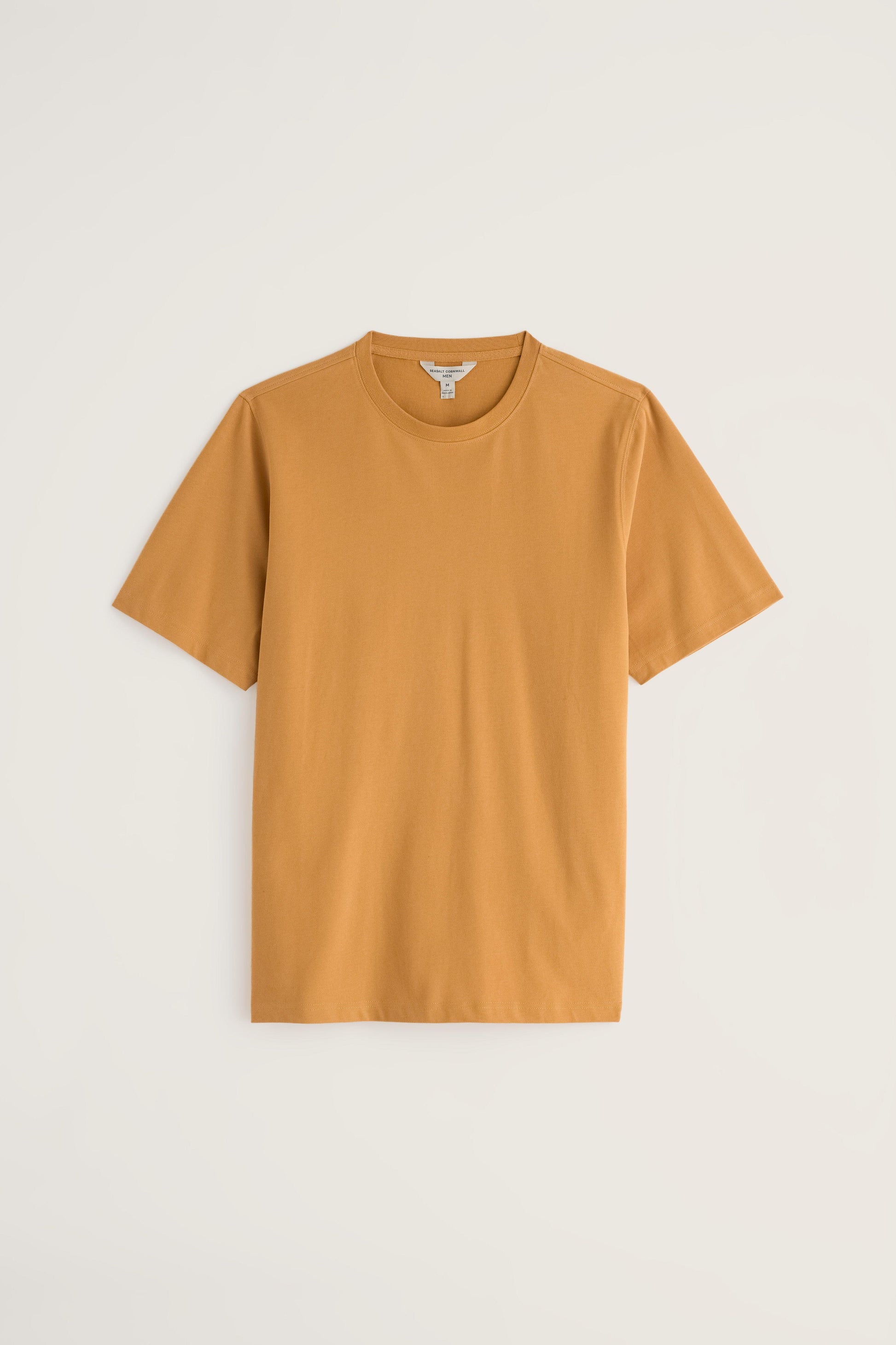 A solid mustard yellow short-sleeve organic cotton men's t-shirt against a plain light background.