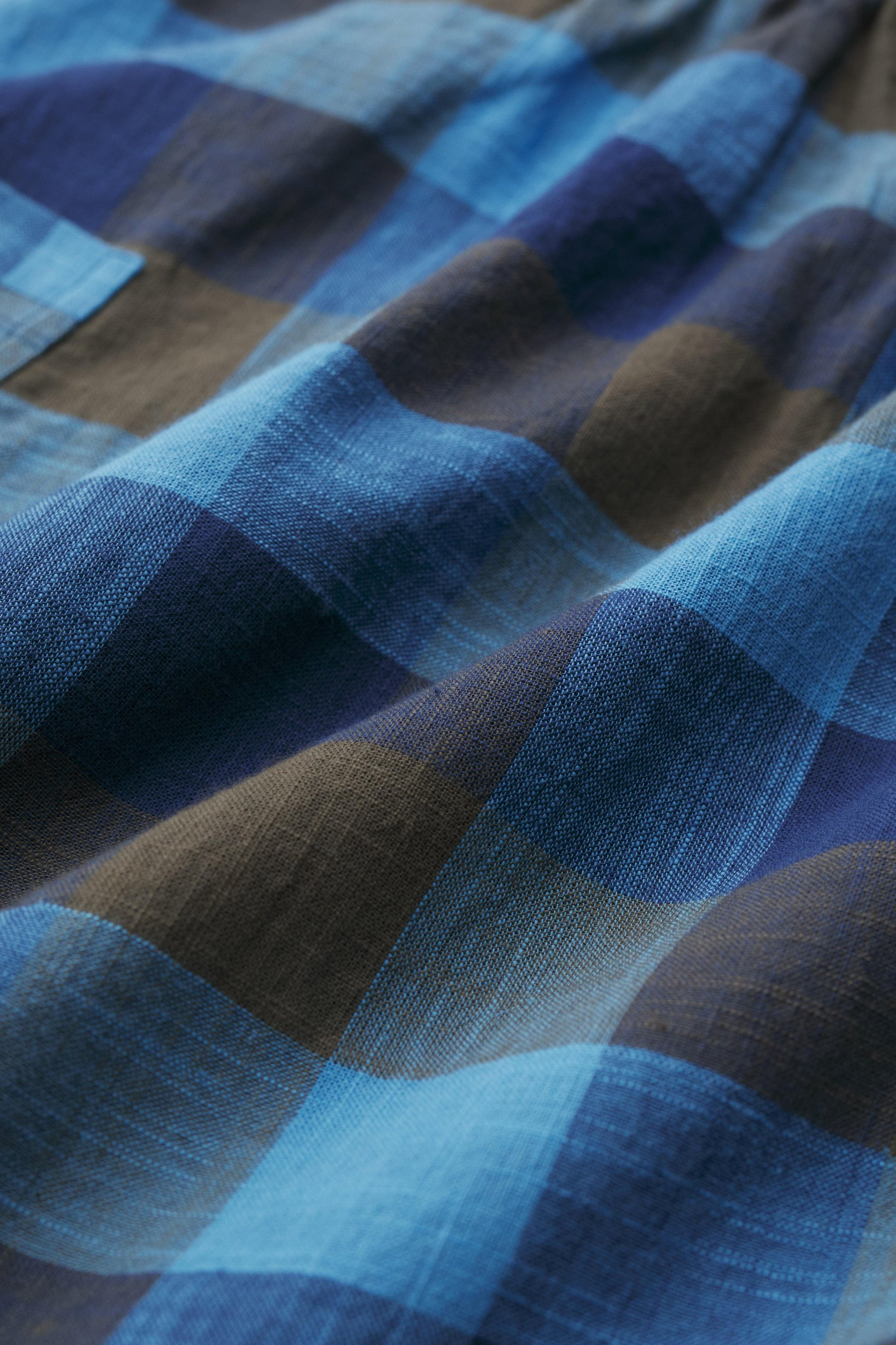 Close-up of blue and brown checkered organic cotton fabric
