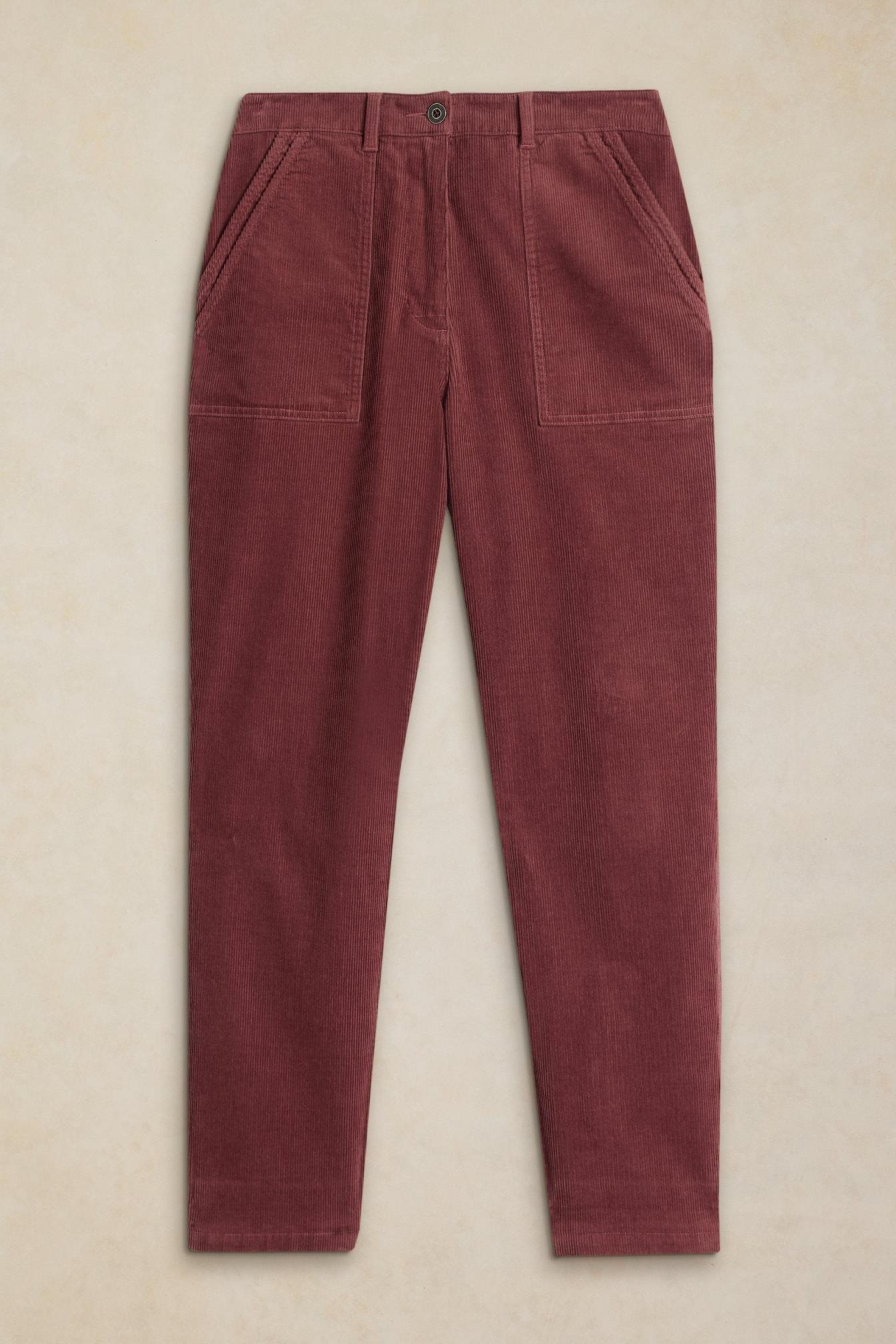 A pair of pink women's organic cotton corduroy trousers against a neutral background.