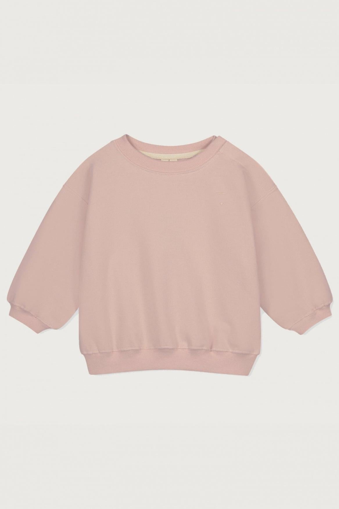 A light pink crewneck sweatshirt with three-quarter length balloon sleeves and ribbed cuffs, hem, and collar, shown flat on a light gray background.