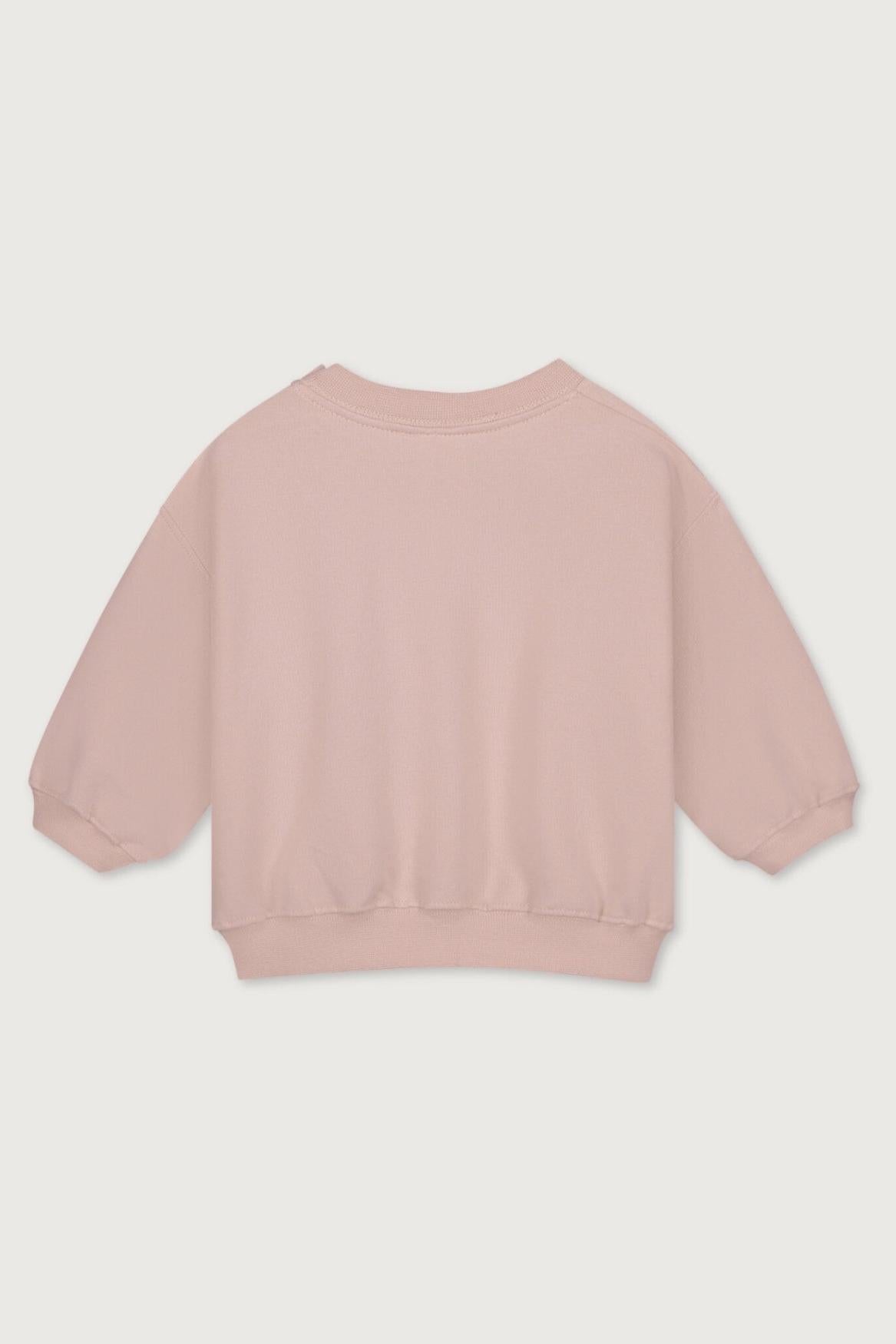 A light pink long-sleeve organic cotton crewneck sweatshirt shown from the back, laid flat against a light gray background.