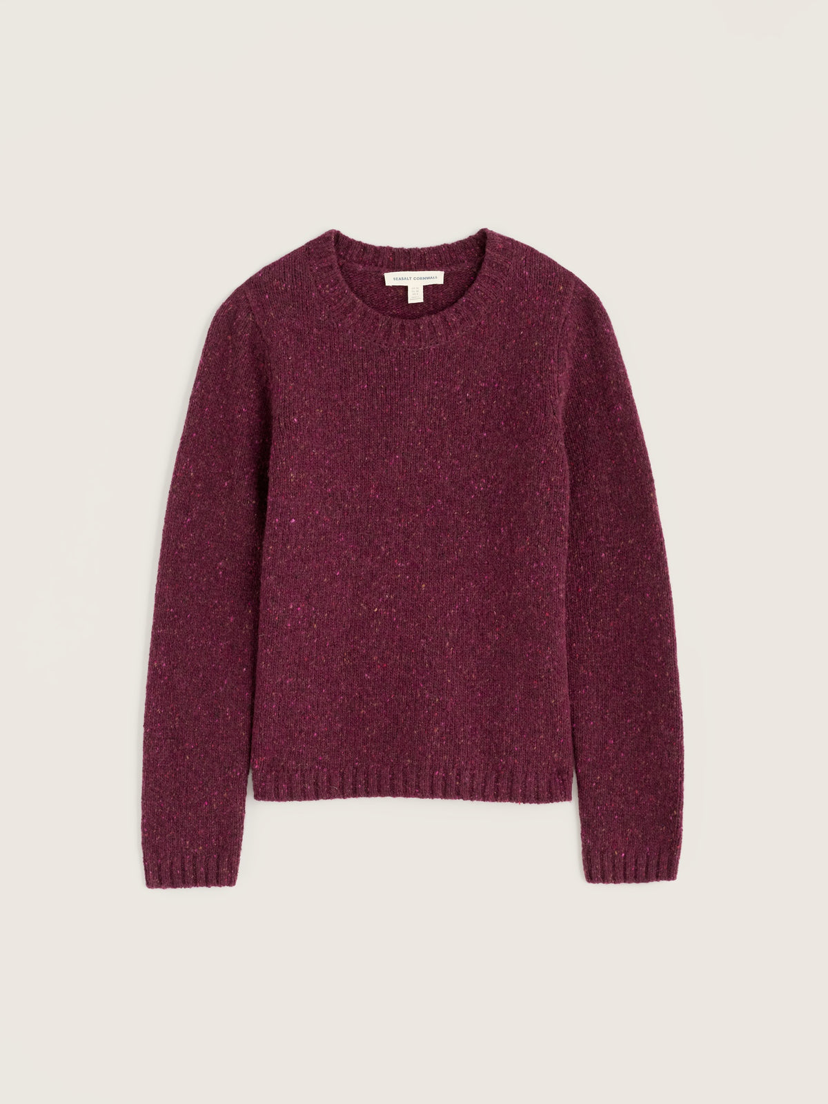A Seasalt Cornwall plum merino wool jumper against a neutral background.