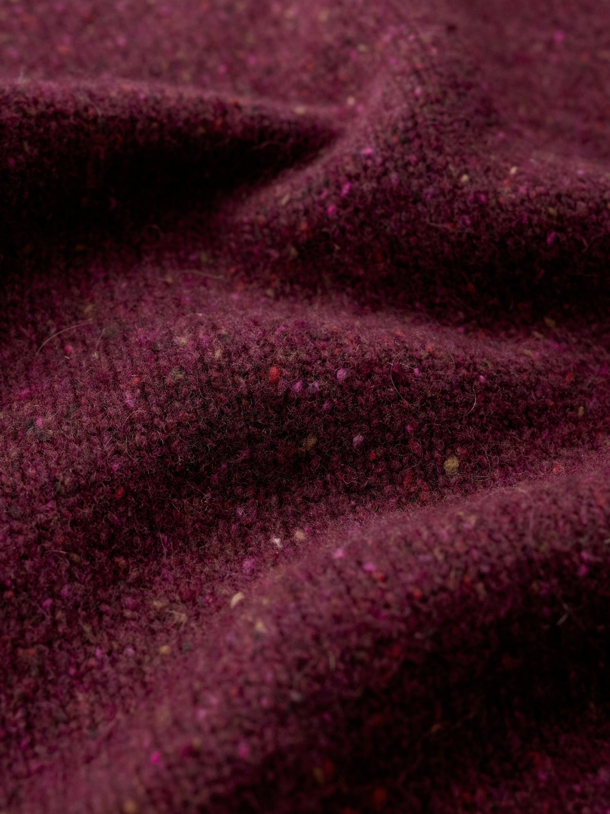 Close up fabric texture of a plum merino wool jumper