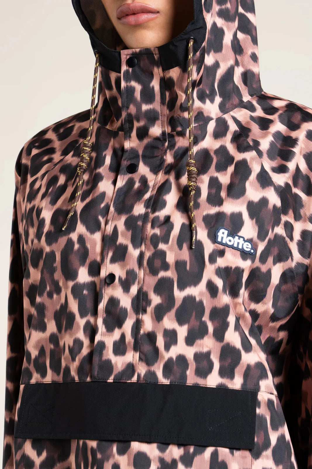 Leopard print raincoat with a Flotte logo on a neutral background