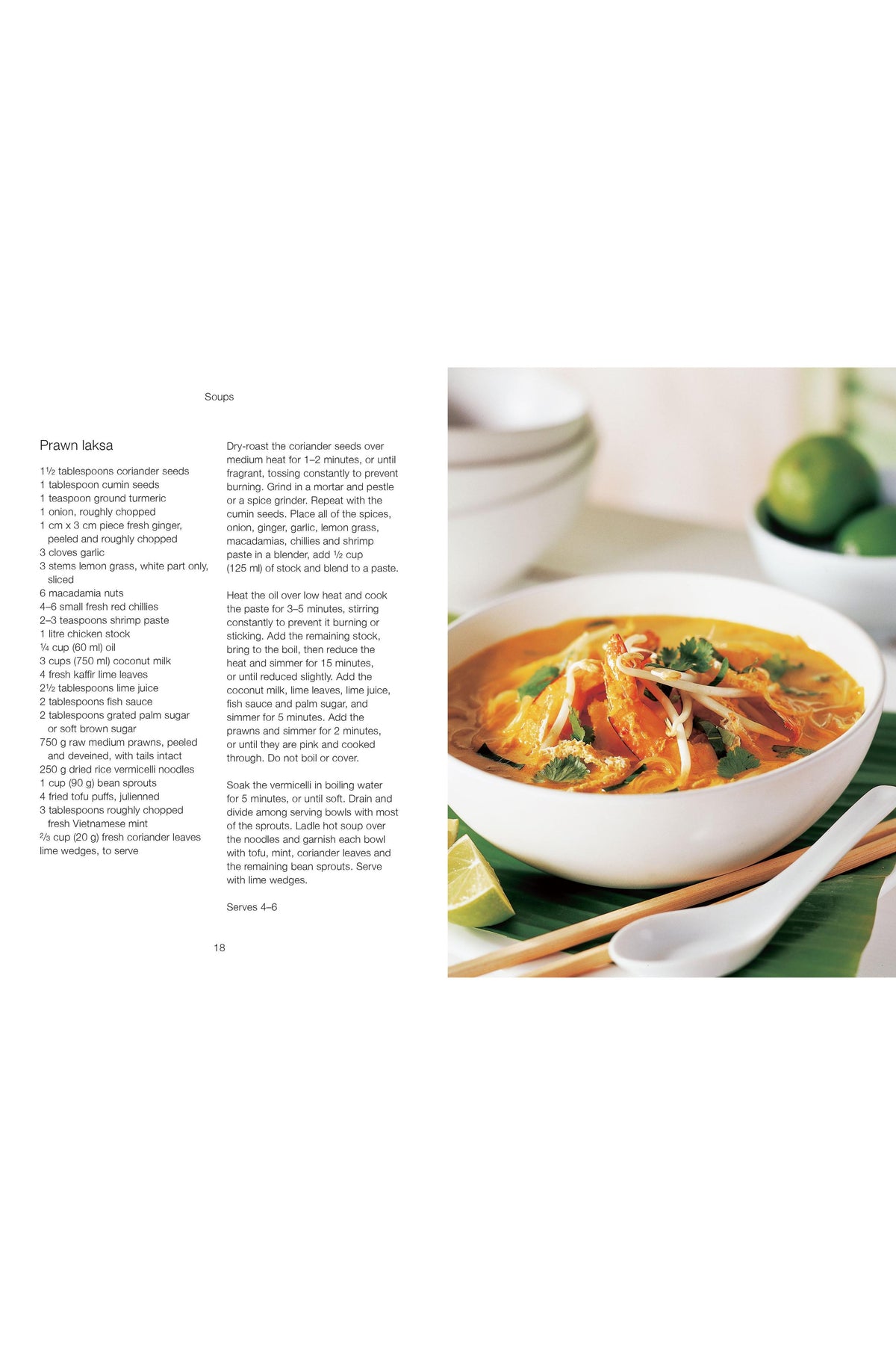 A close-up of a bowl of spicy prawn laksa soup next to a printed recipe page.