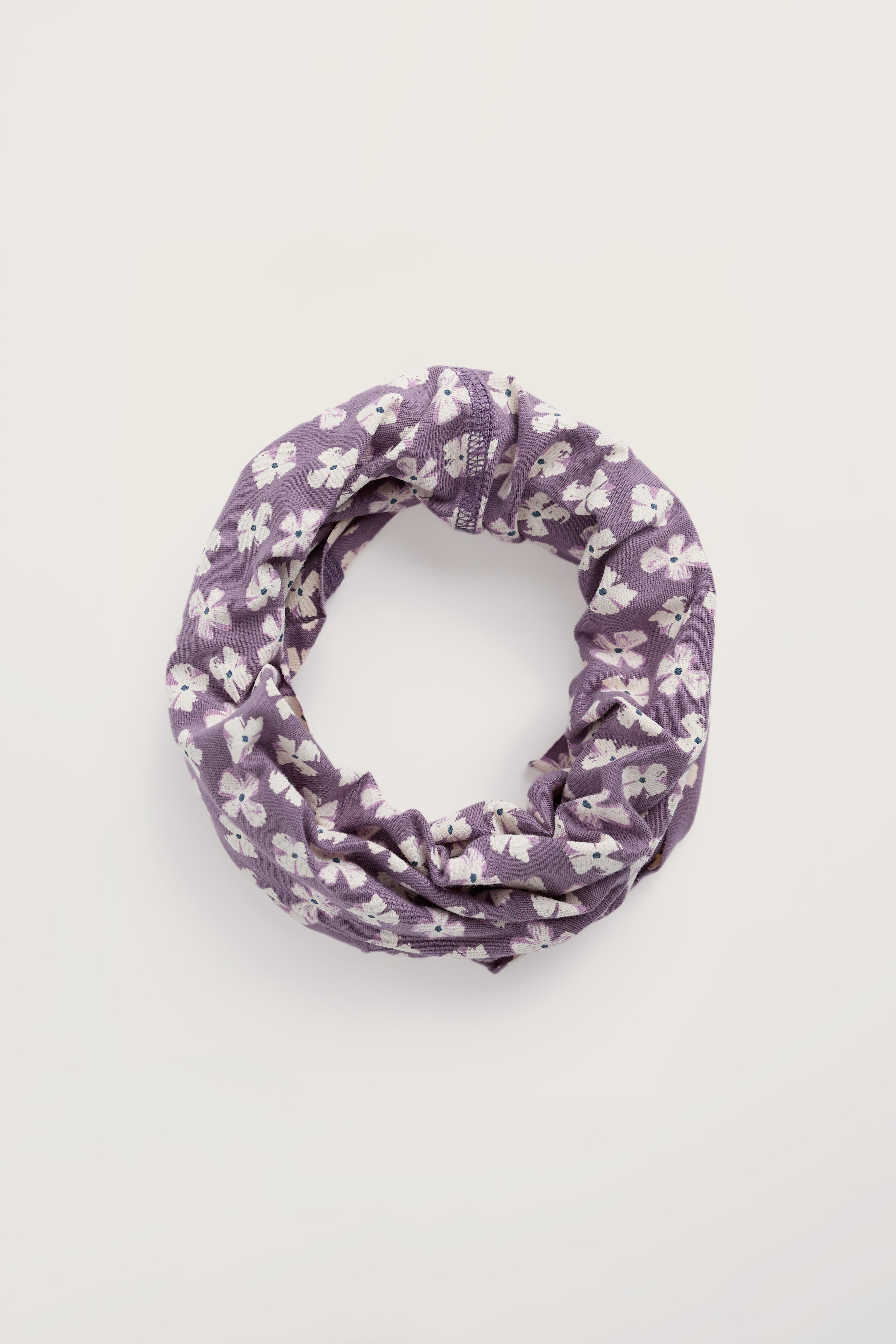 Purple floral patterned snood on a light gray background
