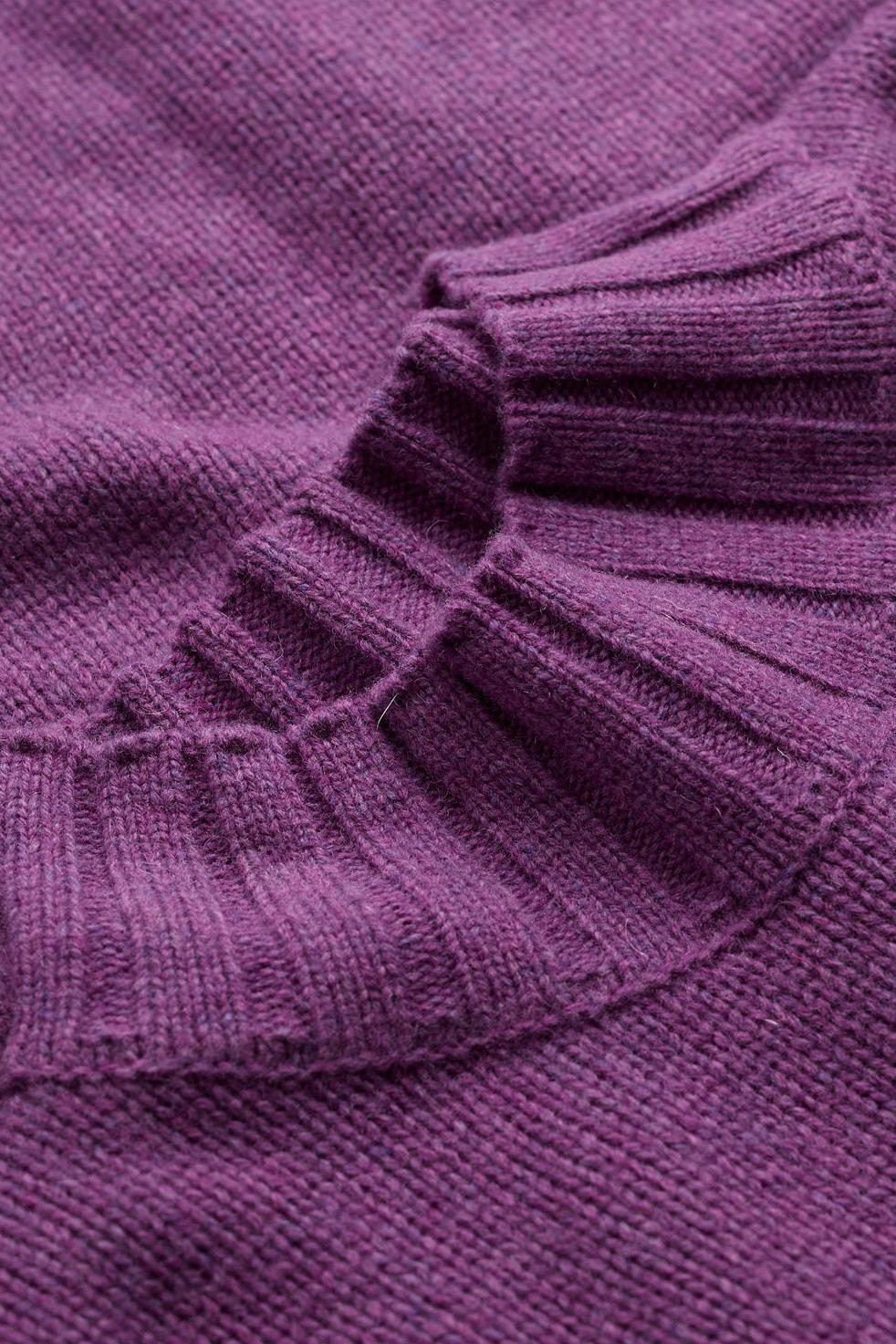 Close-up view of a soft purple lambswool jumper showing the detailed knit sweater texture.