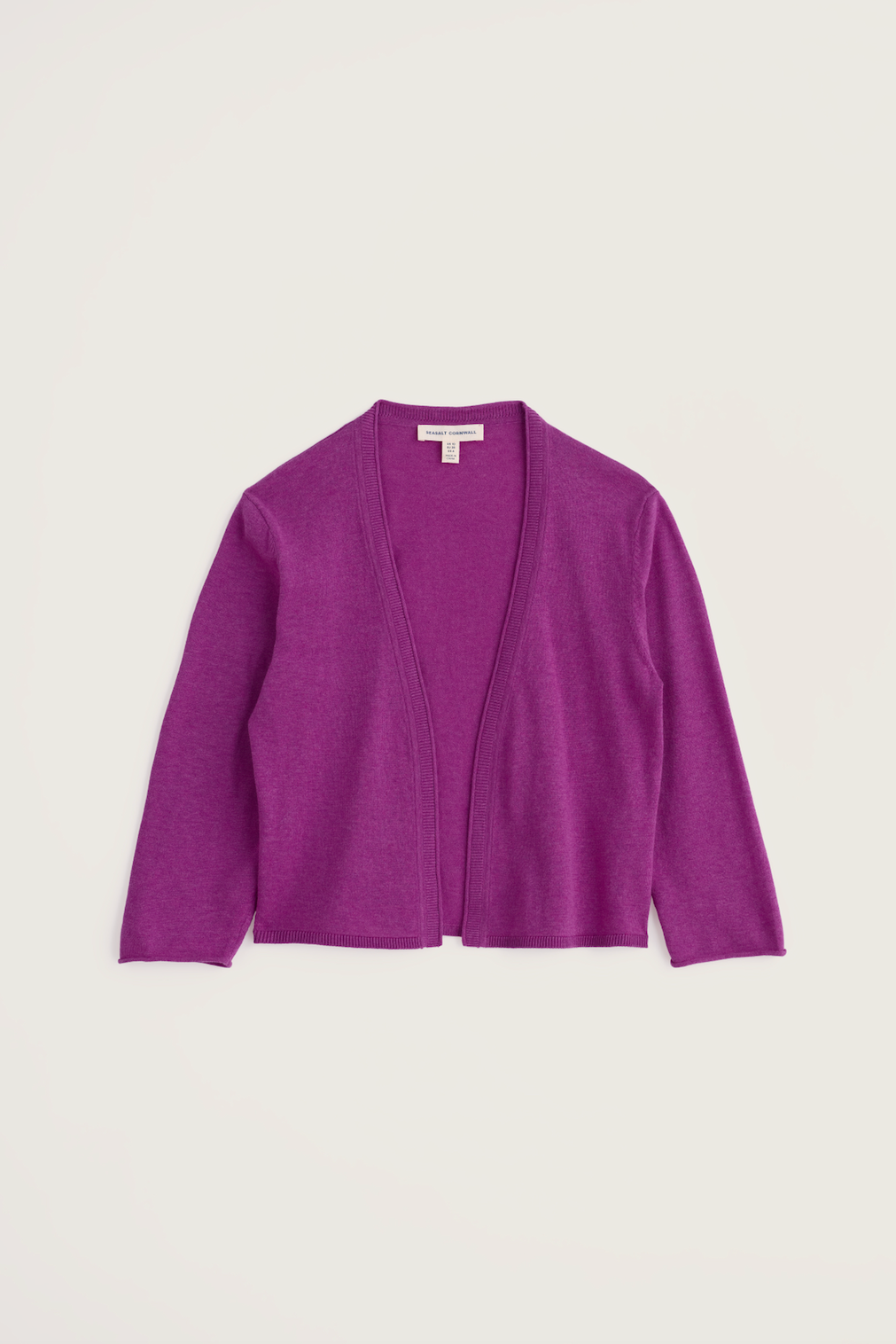 Seasalt Cornwall purple cardigan made from organic cotton against a plain background.
