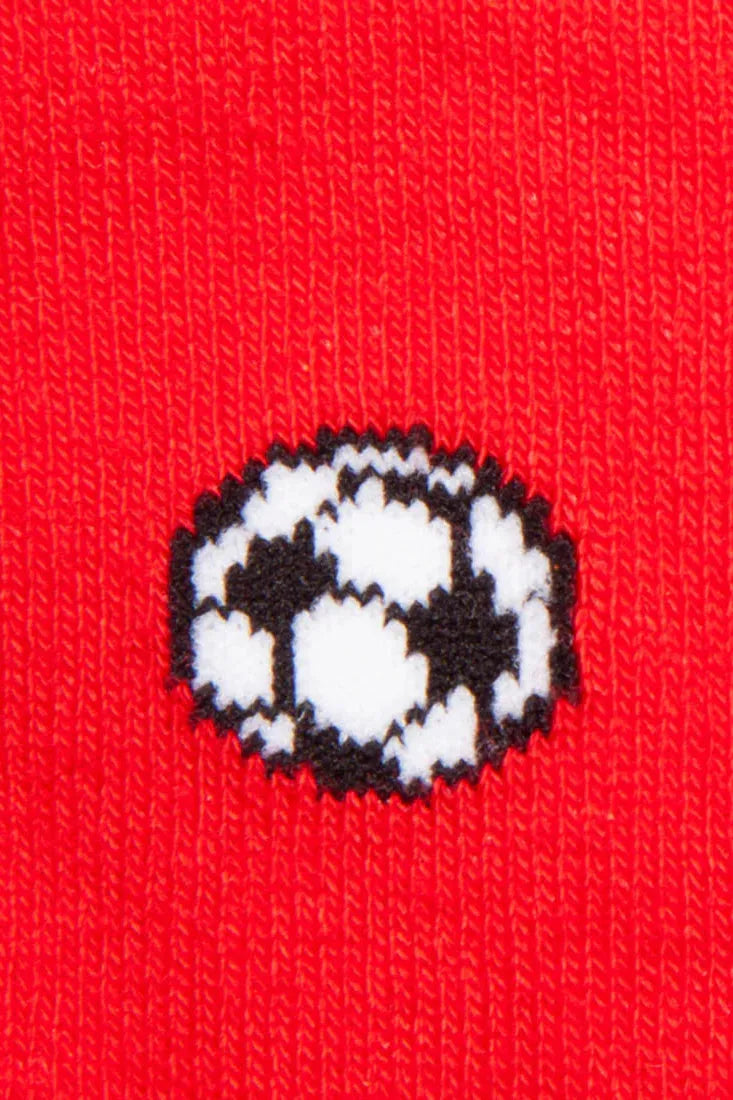 Close-up of red fabric featuring a repeating soccer ball pattern made from bamboo fiber.