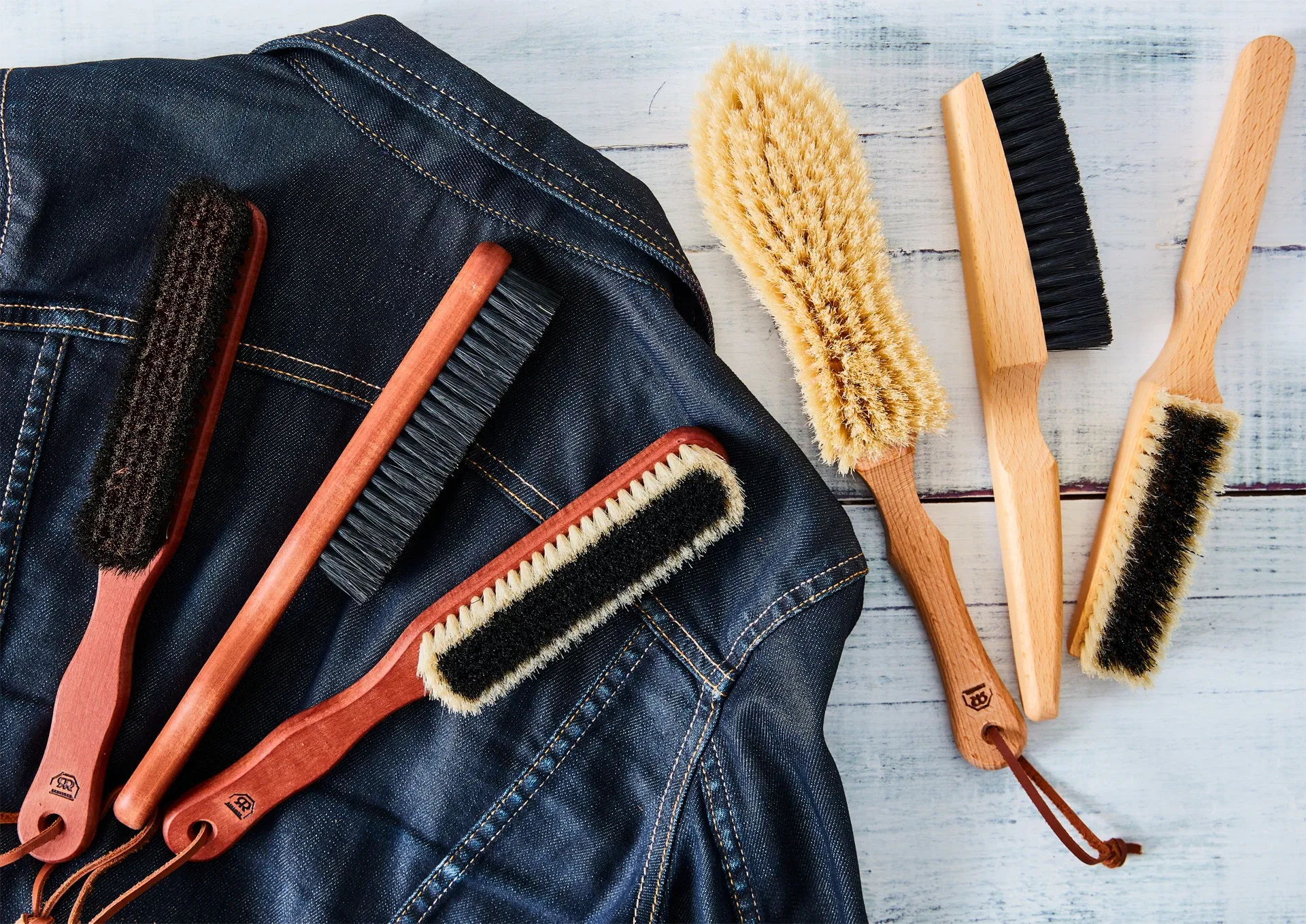Set of cleaning brushes on a denim fabric background