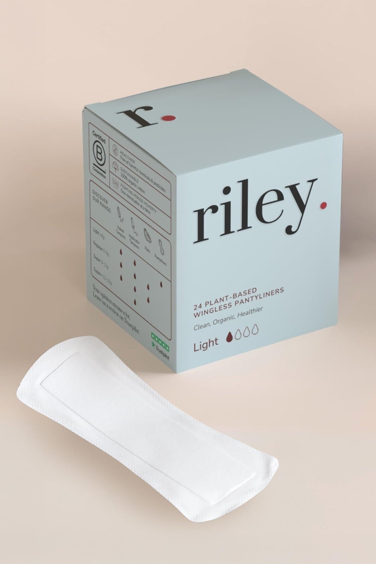 A Riley brand box of plant-based wingless panty liners with a single white absorbent pad placed in front, set against a solid beige background.