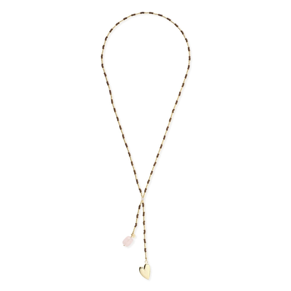 A delicate lariat style necklace with a rose quartz gemstone and a gold heart charm.