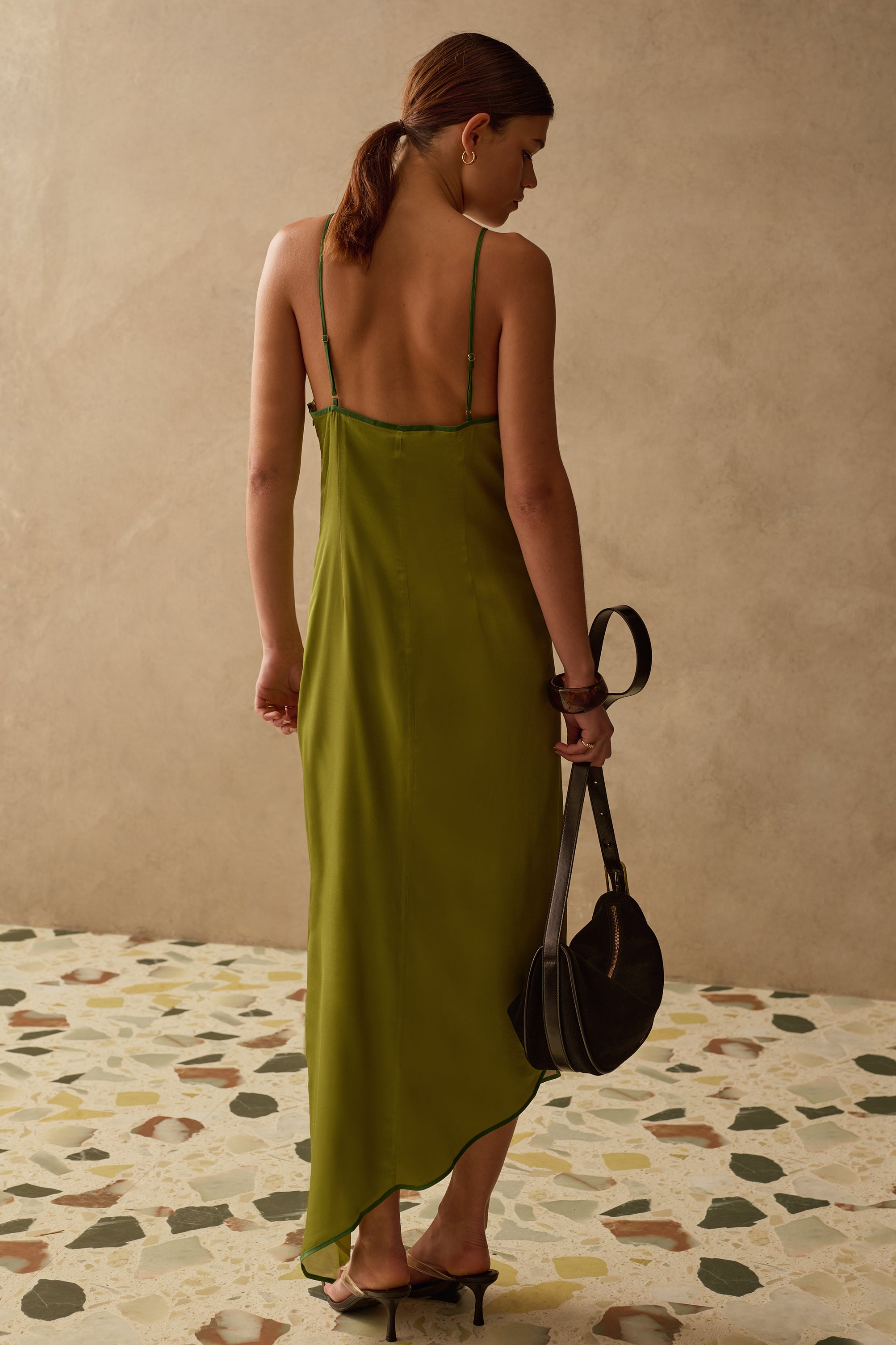 Back view of model wearing a Sancia green midi dress 