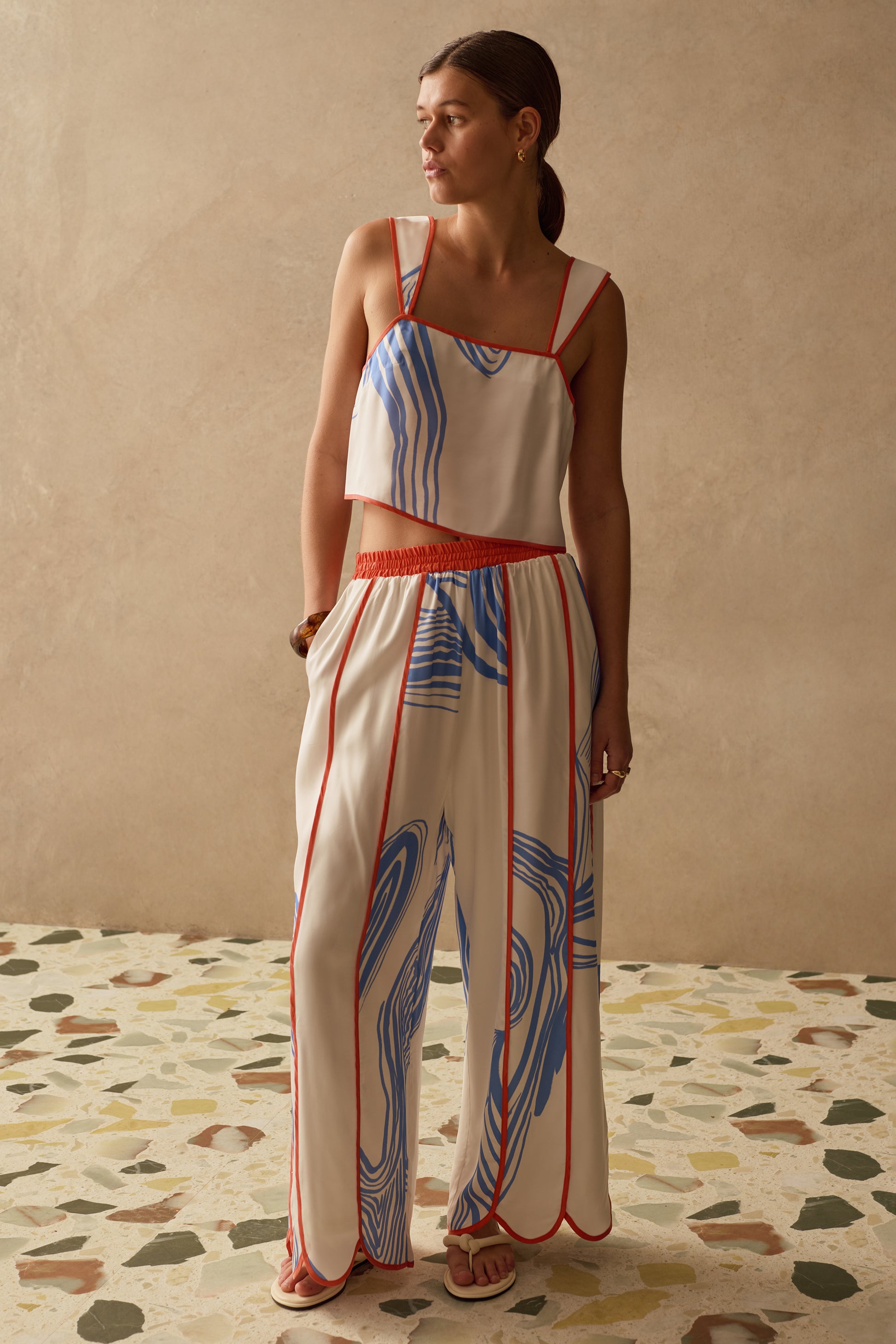 Woman wearing a colorful two piece with a neutral background