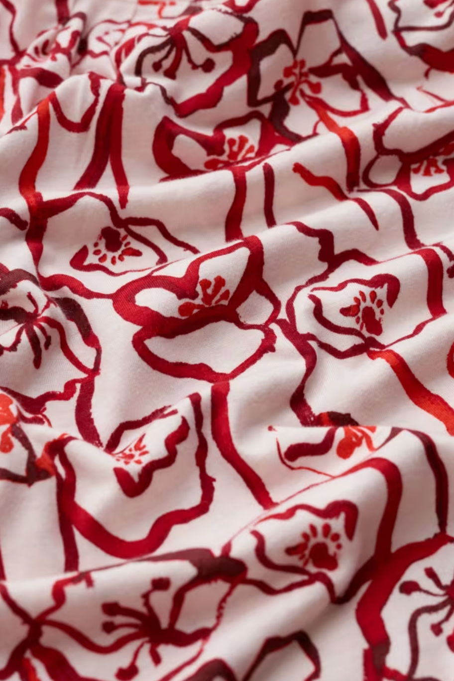 Close-up of red floral pattern on white fabric