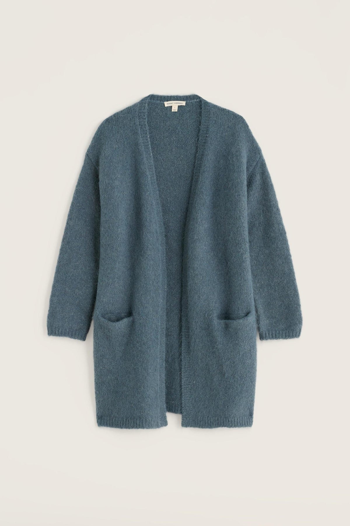 A long blue Seasalt Cornwall open-front cardigan featuring two front pockets against a light background.