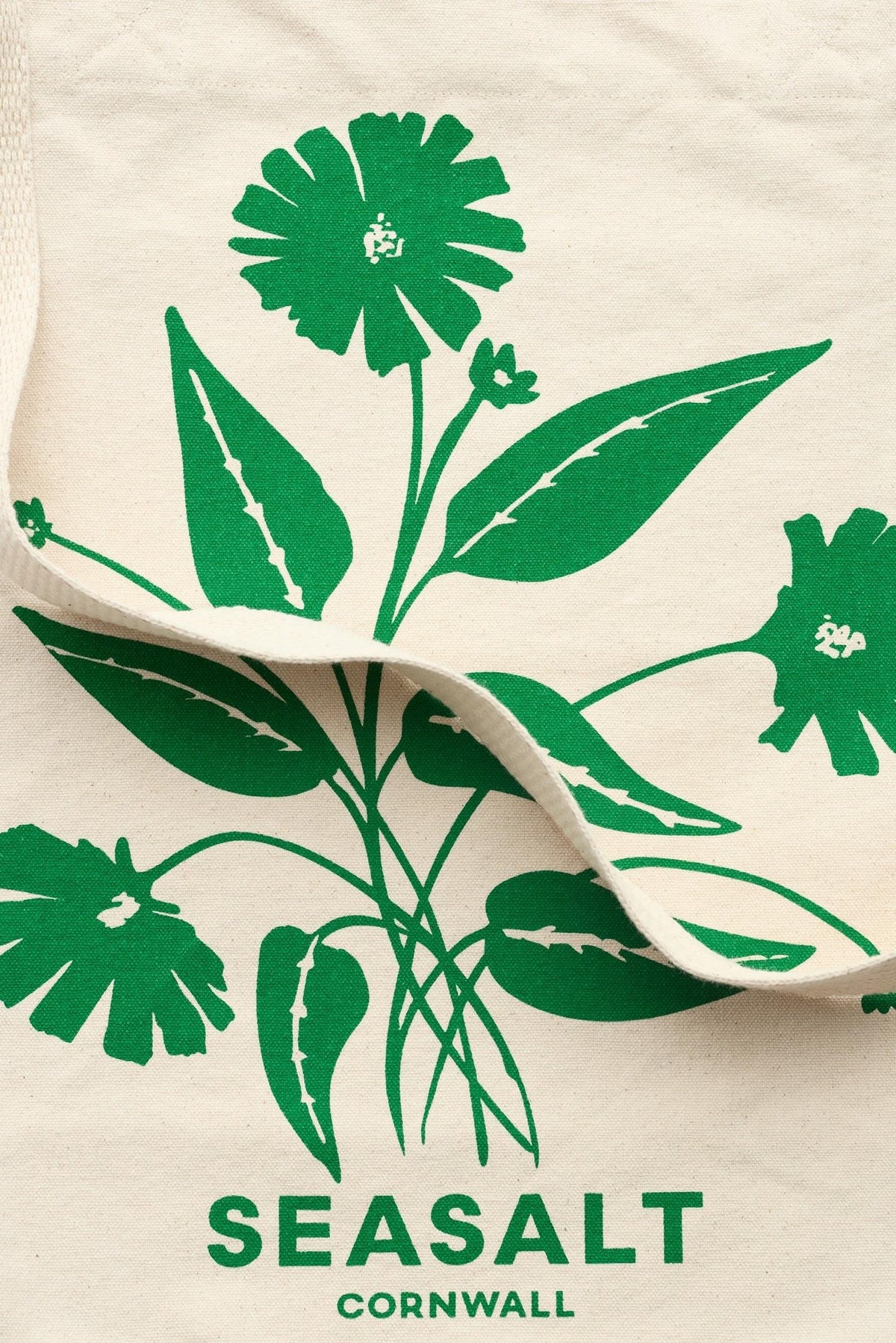 Seasalt Cornwall natural canvas shopping tote featuring a green botanical spring print.