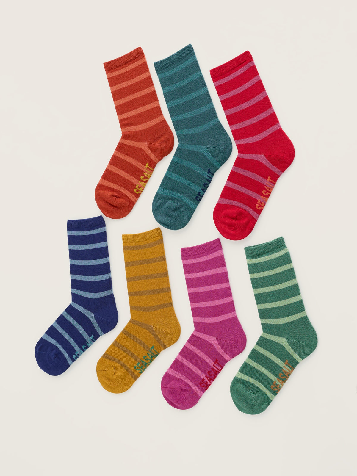 Seven colourful striped bamboo socks from Seasalt Cornwall arranged on a light background.