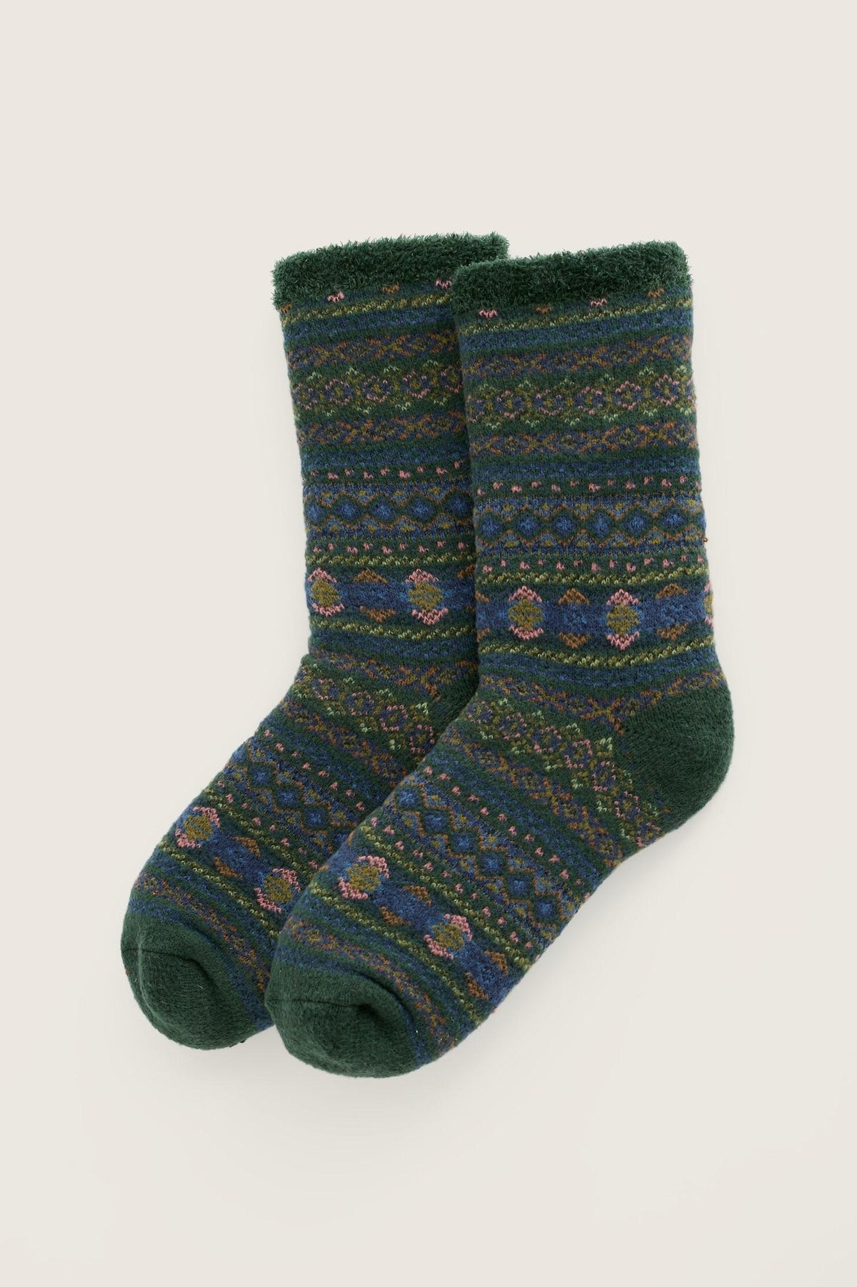 A pair of Seasalt Cornwall green fair isle cosy men's socks against a neutral background.