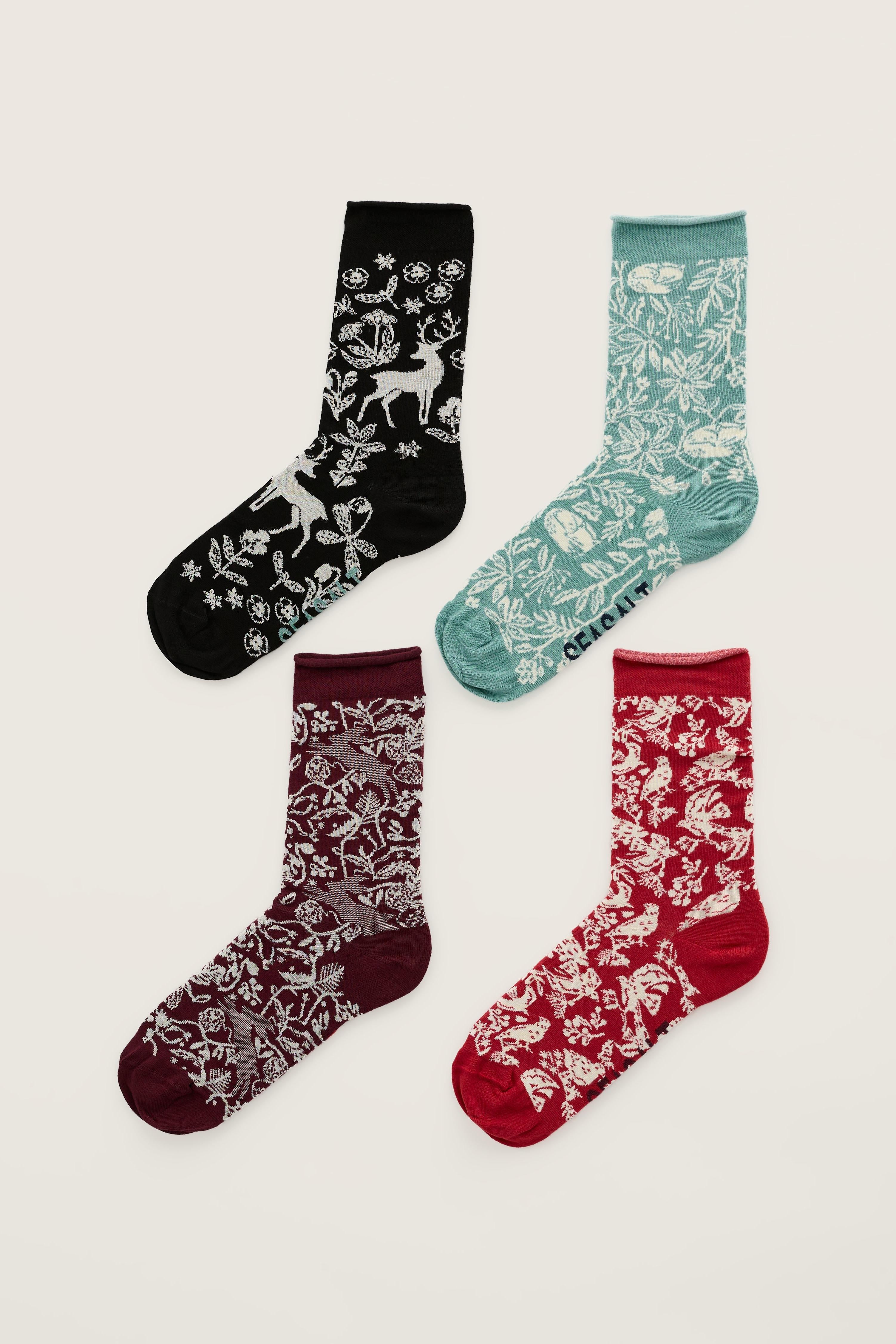 Four pairs of Seasalt Cornwall festive patterned bamboo socks arranged on a plain background.