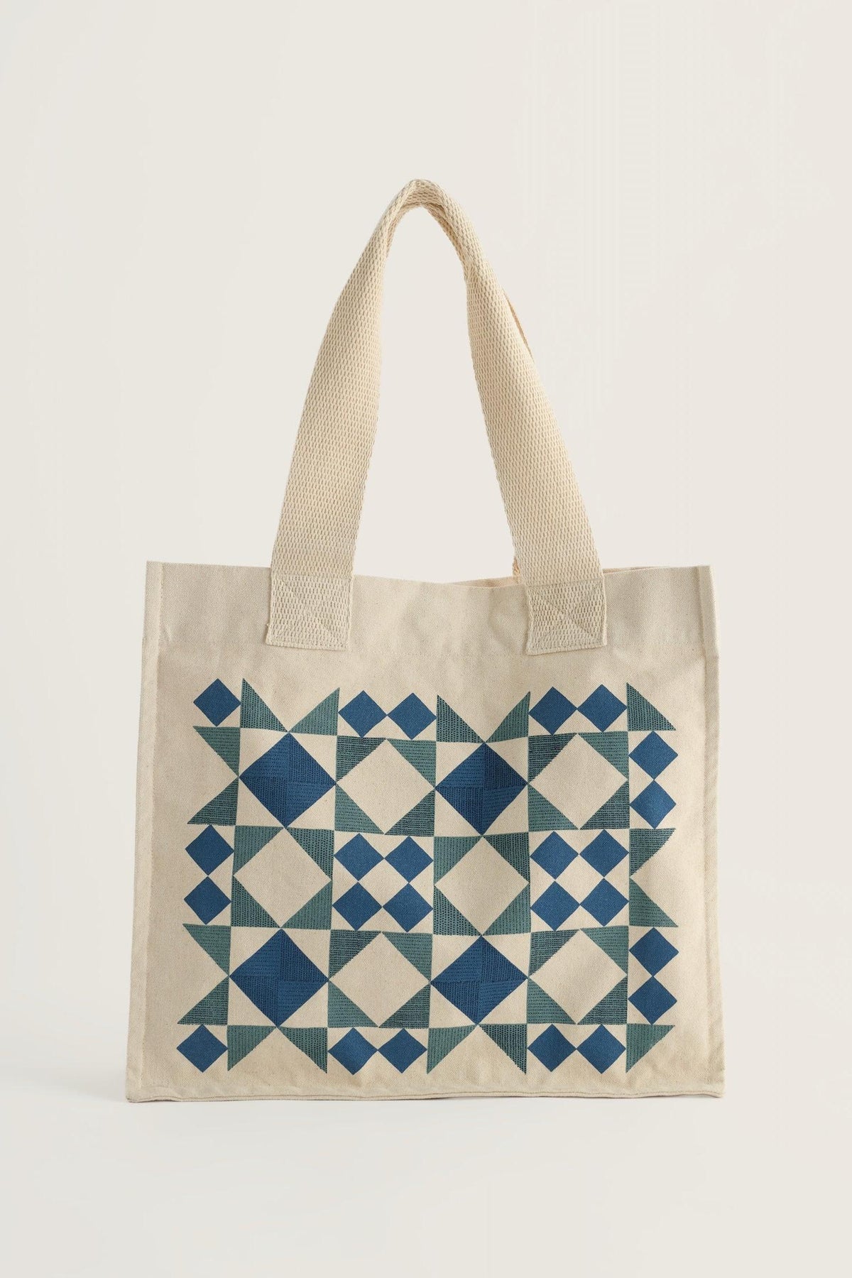 Seasalt Cornwall canvas bag with blue and teal geometric quilt-style pattern on a neutral background.