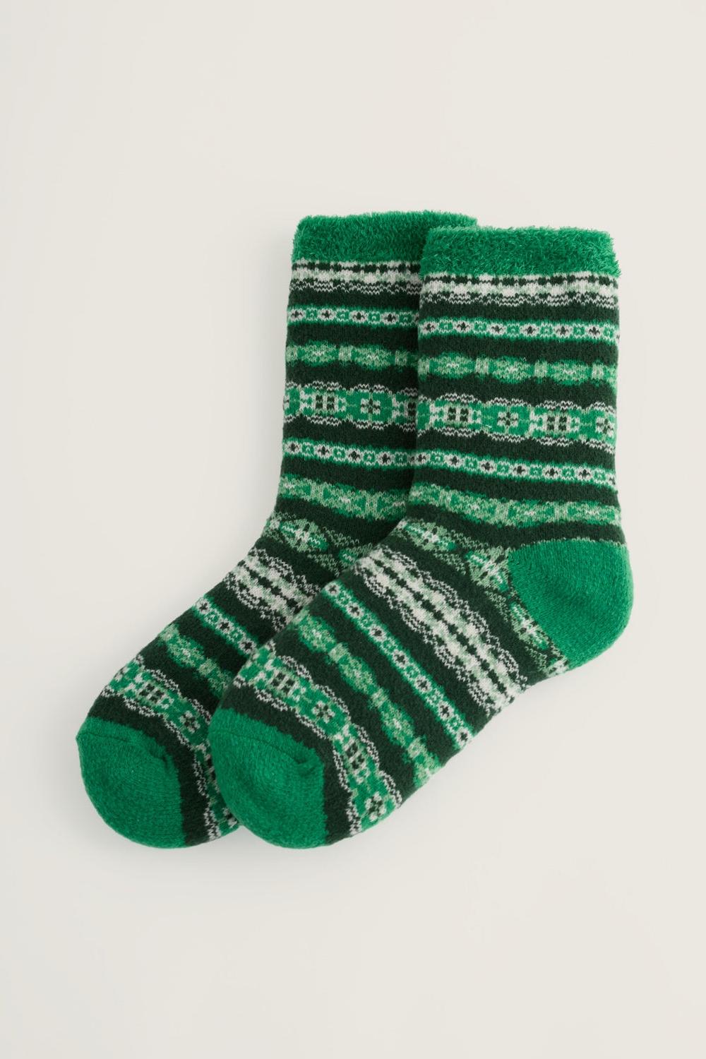 A pair of green patterned Seasalt Cornwall cosy slipper socks made from recycled polyester against a plain background.