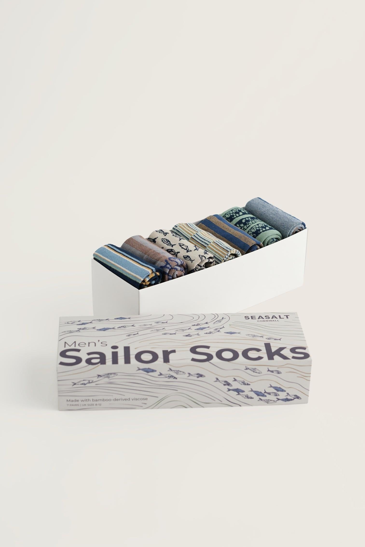 A Seasalt Cornwall men's gift box containing seven pairs of patterned bamboo socks.