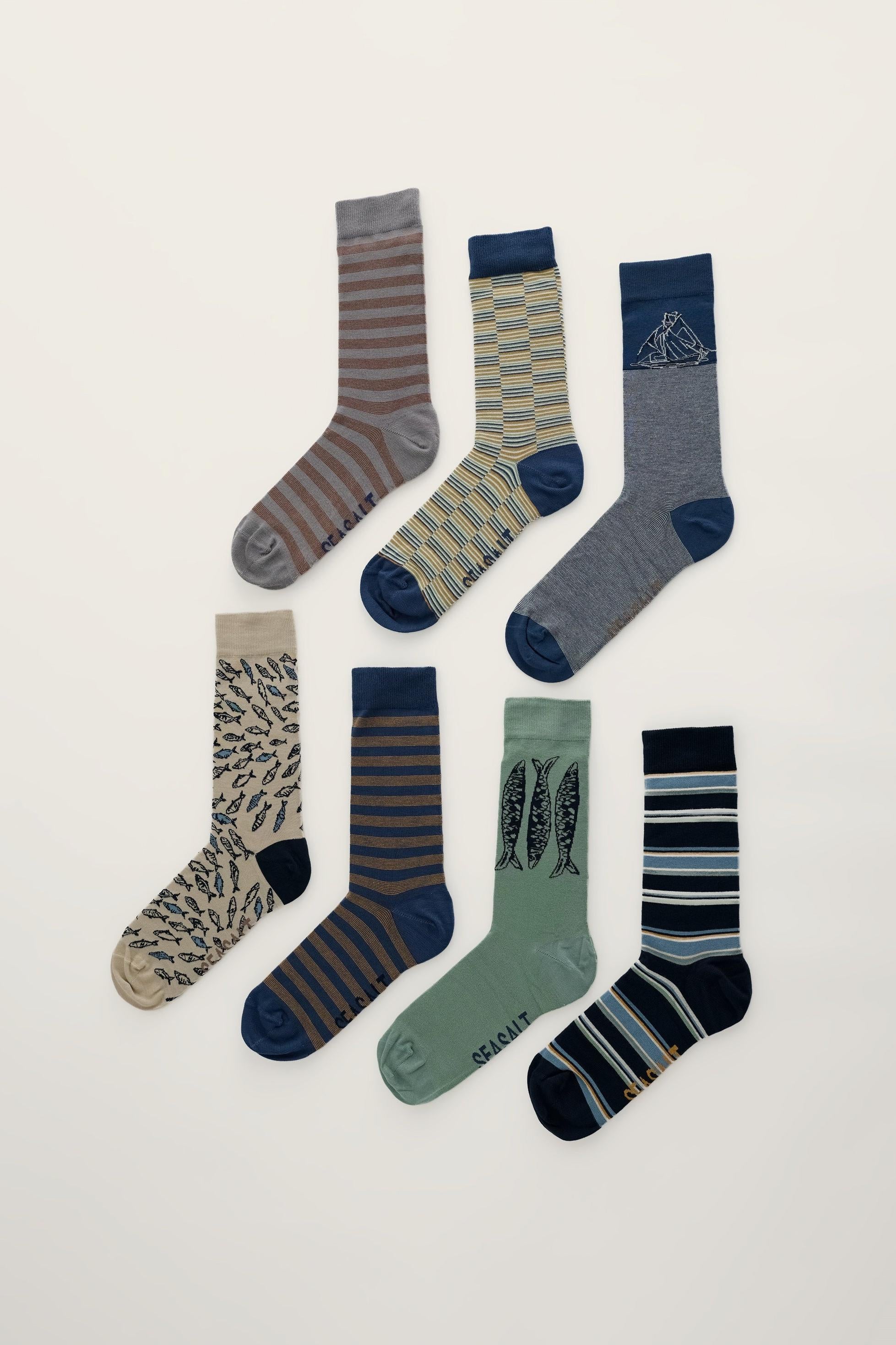 Set of seven Seasalt Cornwall patterned bamboo socks for men arranged on a light background.